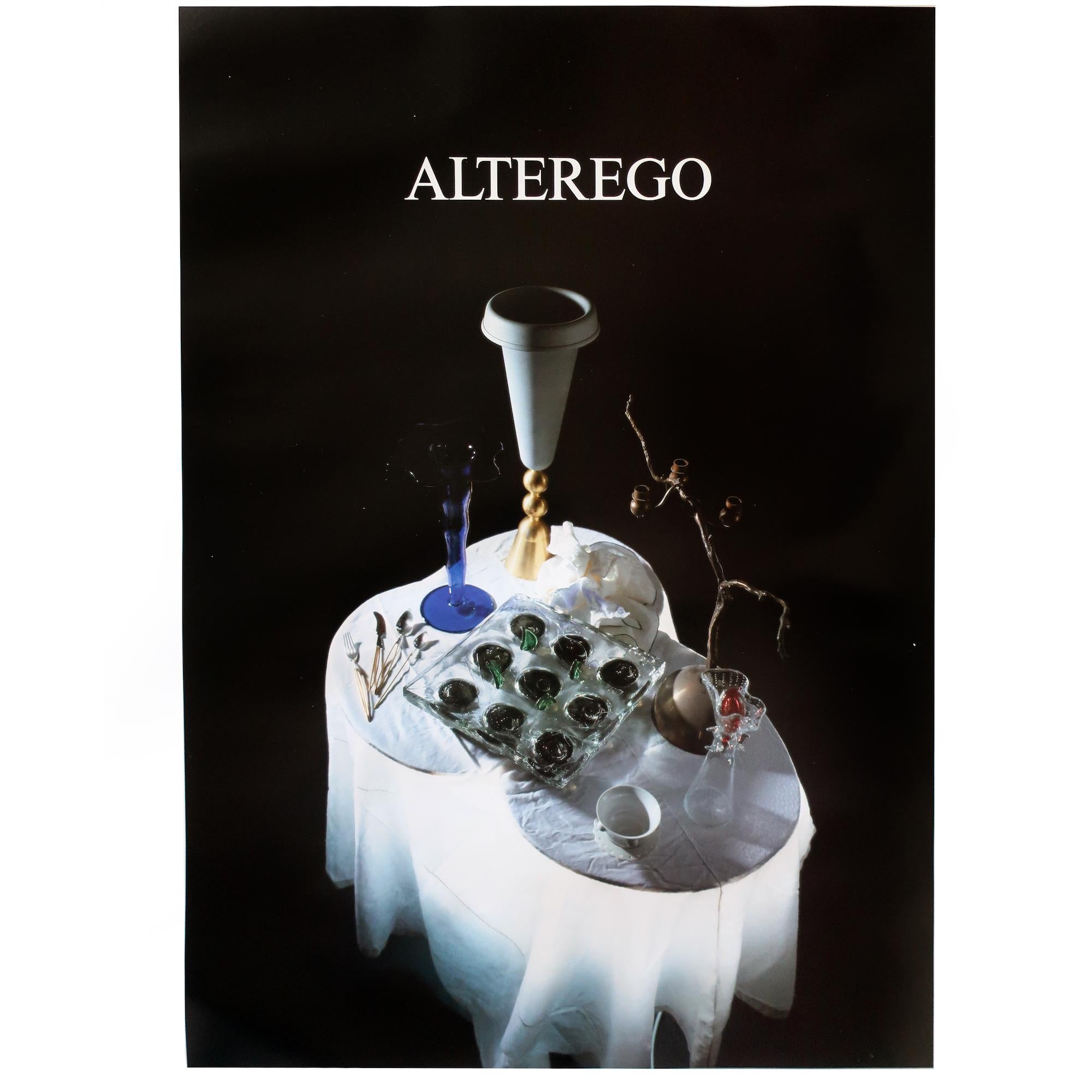 A promotional poster for Czech architect and designer Borek Sipek's work with his design studio Alterego producing works in glass in the 1980s and 1990s. Features a number of Sipek designed pieces on a white table cloth covered table.