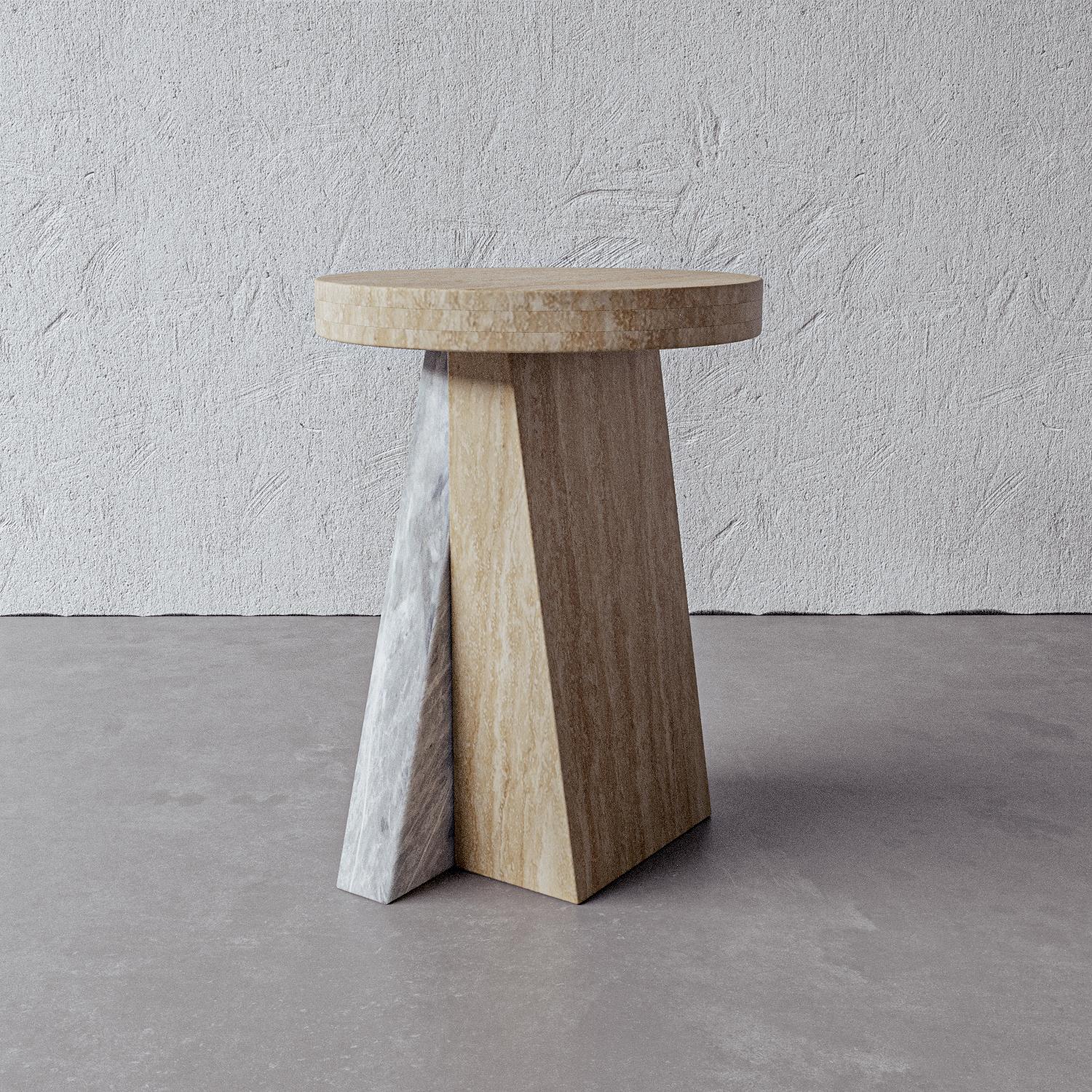 This asymmetrical side table inspired by modern sculpture features an angular mixed slab base in grey and cream travertine with a honed travertine top. Handmade by artisans in Vietnam, this piece adds a feminine depth to any space.