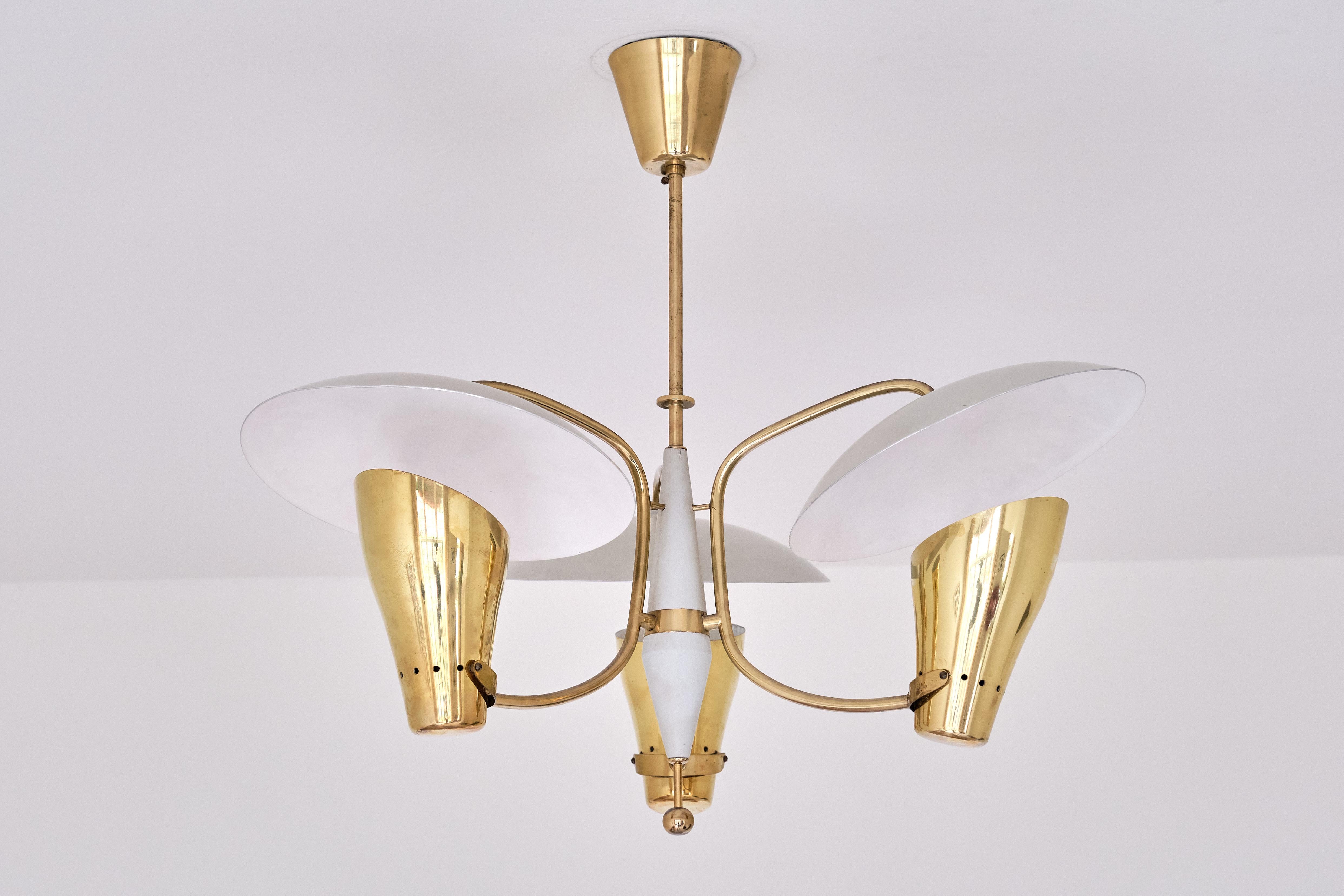 This exceptionally rare chandelier/ceiling light was produced by Boréns in Borås, Sweden in the early 1950s. The elegant design consists of three brass shades with a perforated detail across the lower part of the sconces. Placed above the brass