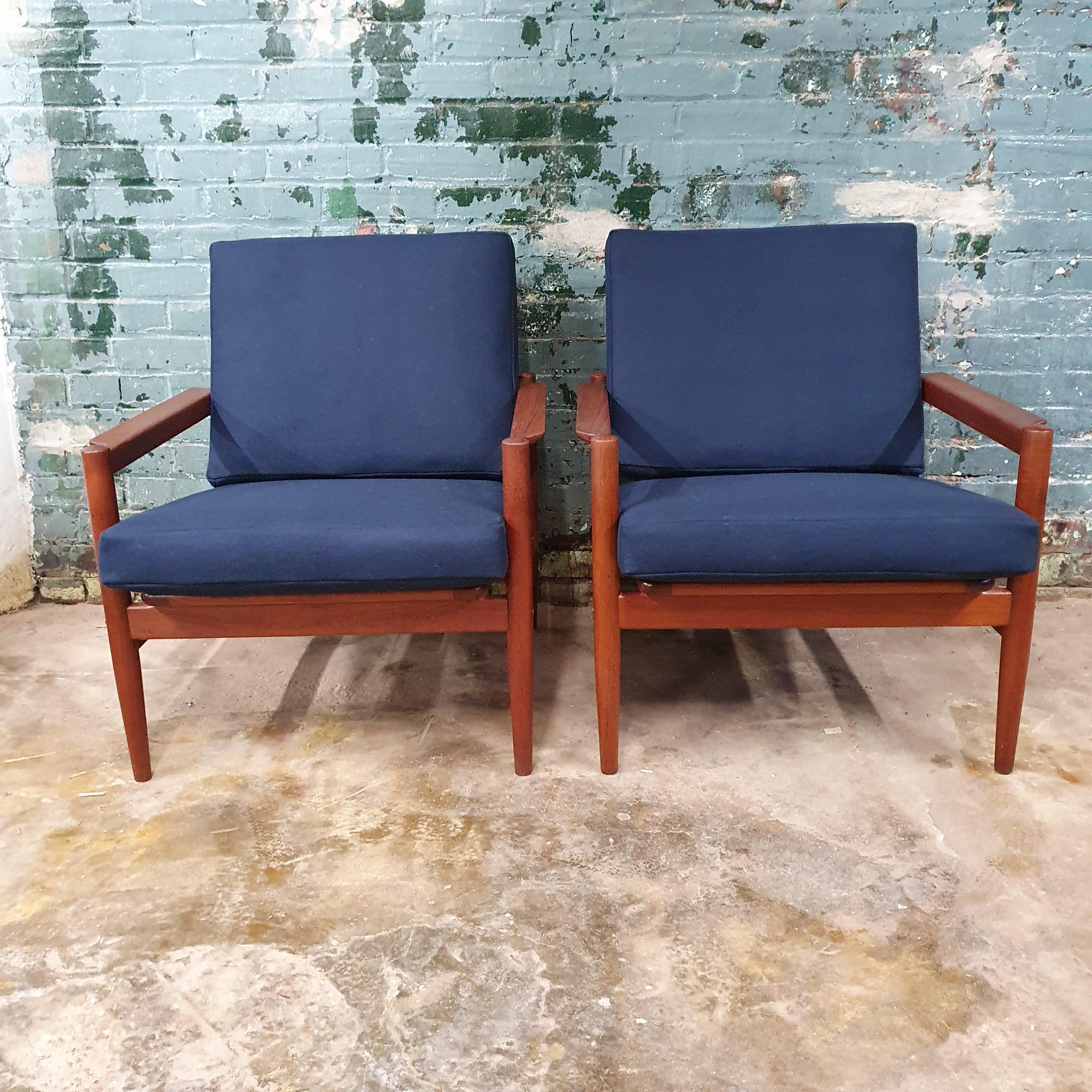 Pair of beautiful teak danish modern lounge chairs by Borge Jensen & Sonner for Bernstorffsminde Møbelfabrik in Denmark, circa 1960s. Frame is in great shape and has been reoiled. new navy maharam wool fabric upholstery and foam.