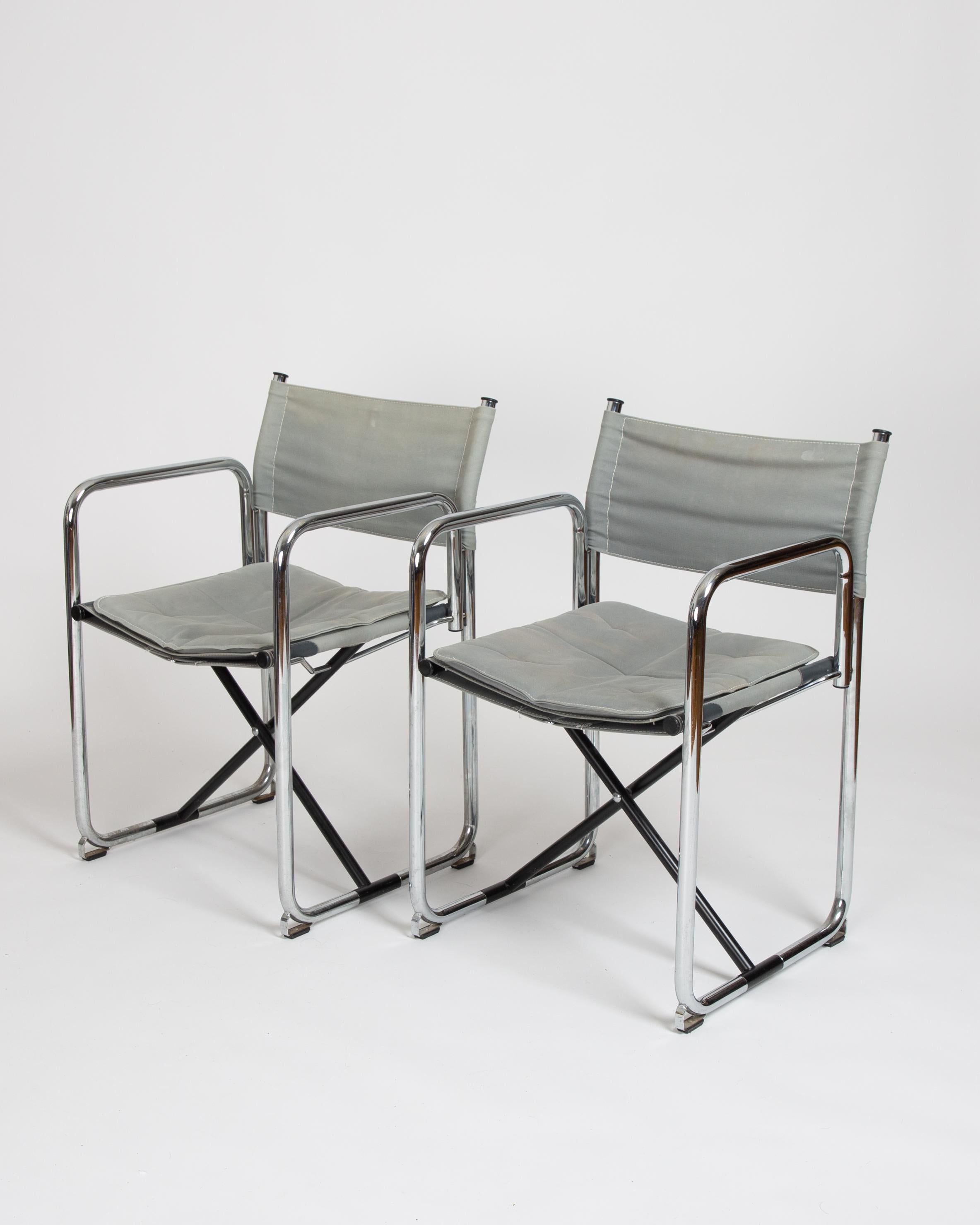 A pair of perfectly faded X75-2 chairs. One of the most compelling foldable chair ever made. Tubular steel and canvas make up this iconic director chair. The ‘X’ denotes the cross beneath the seat in the middle of the chair. Most director chairs