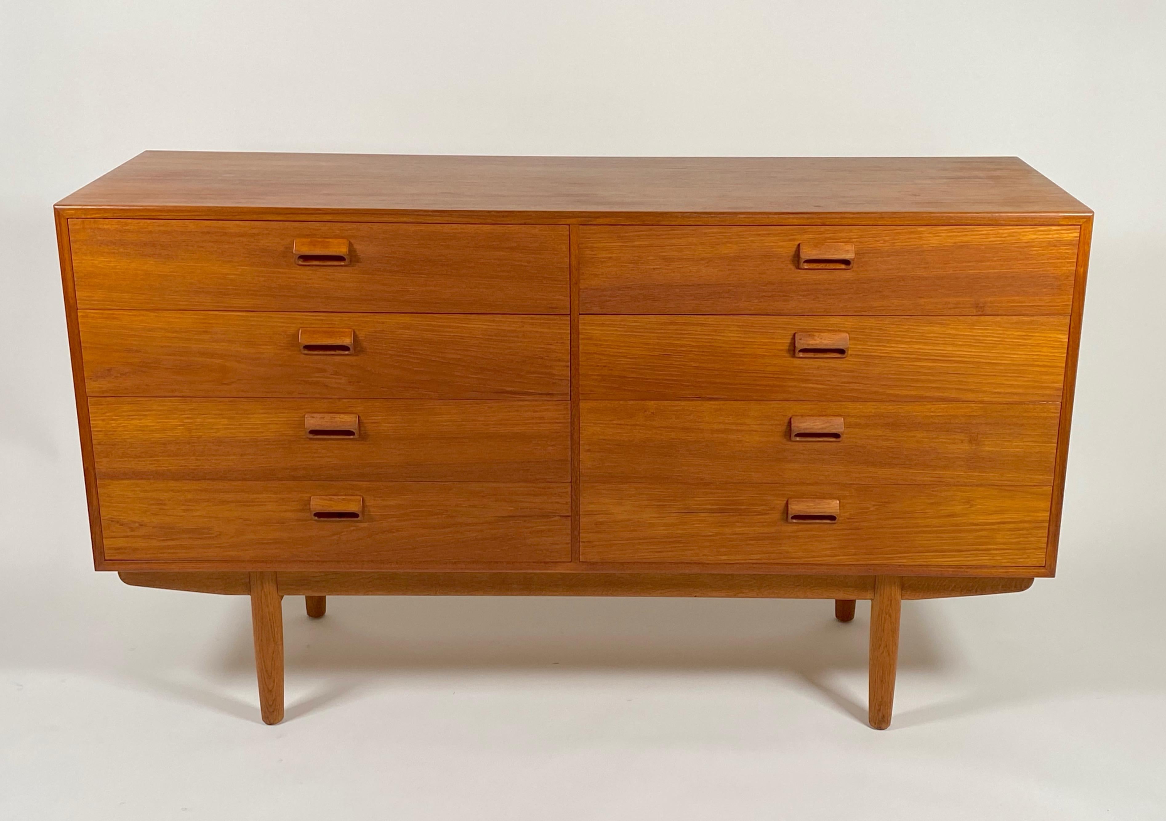 Eight drawer dresser circa 1950s by Danish designer Borge Mogensen (1914-1972). Construction is of old growth teak and the secondary construction is of solid birch. The pulls are carved out of solid teak, resting on a sled base with tapered dowel