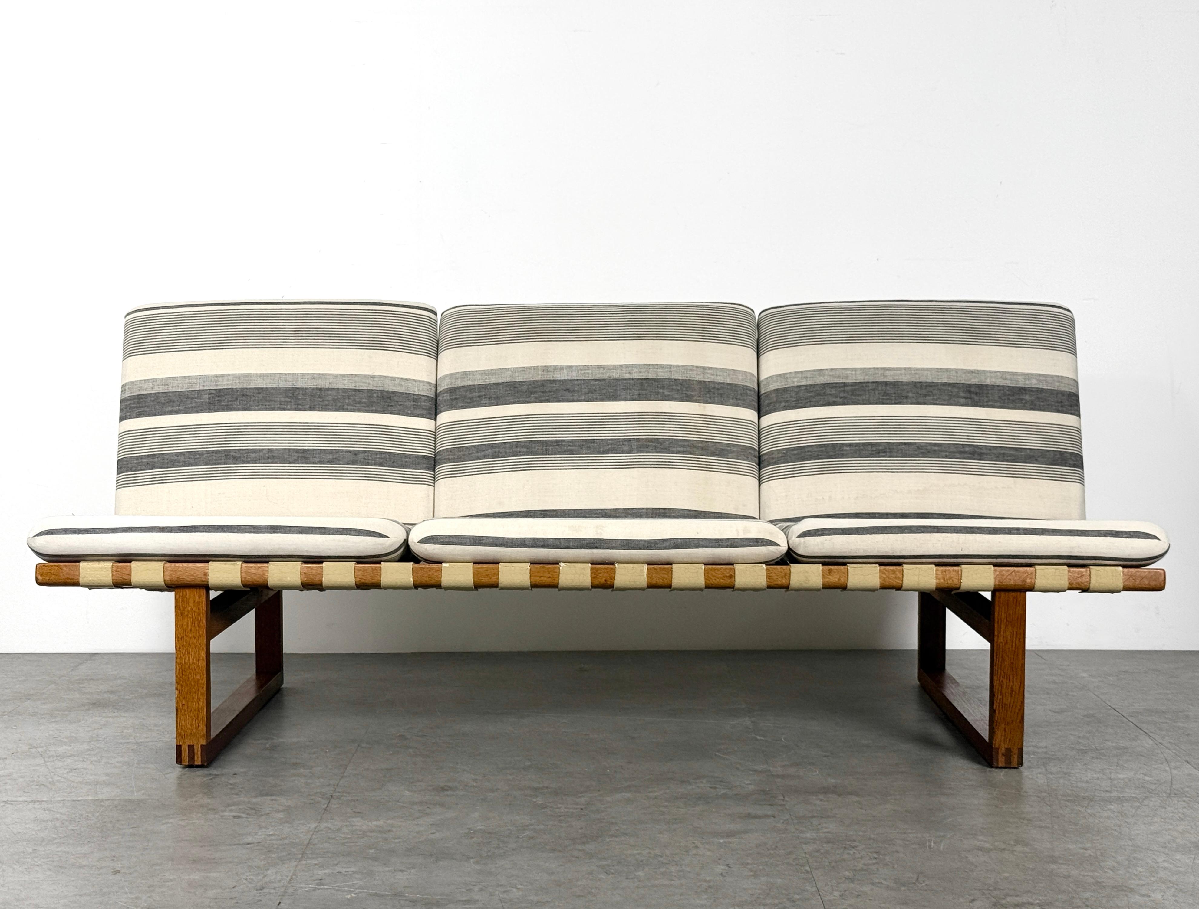 Børge Mogensen 211 Sofa for Fredericia Stolefabrik
Denmark circa 1957

Solid oak and teak frame with finger joint detail and exposed webbing
Loose seat cushions in a period striped cotton-linen textile

63 inch width
27.5 inch depth
26.5 inch