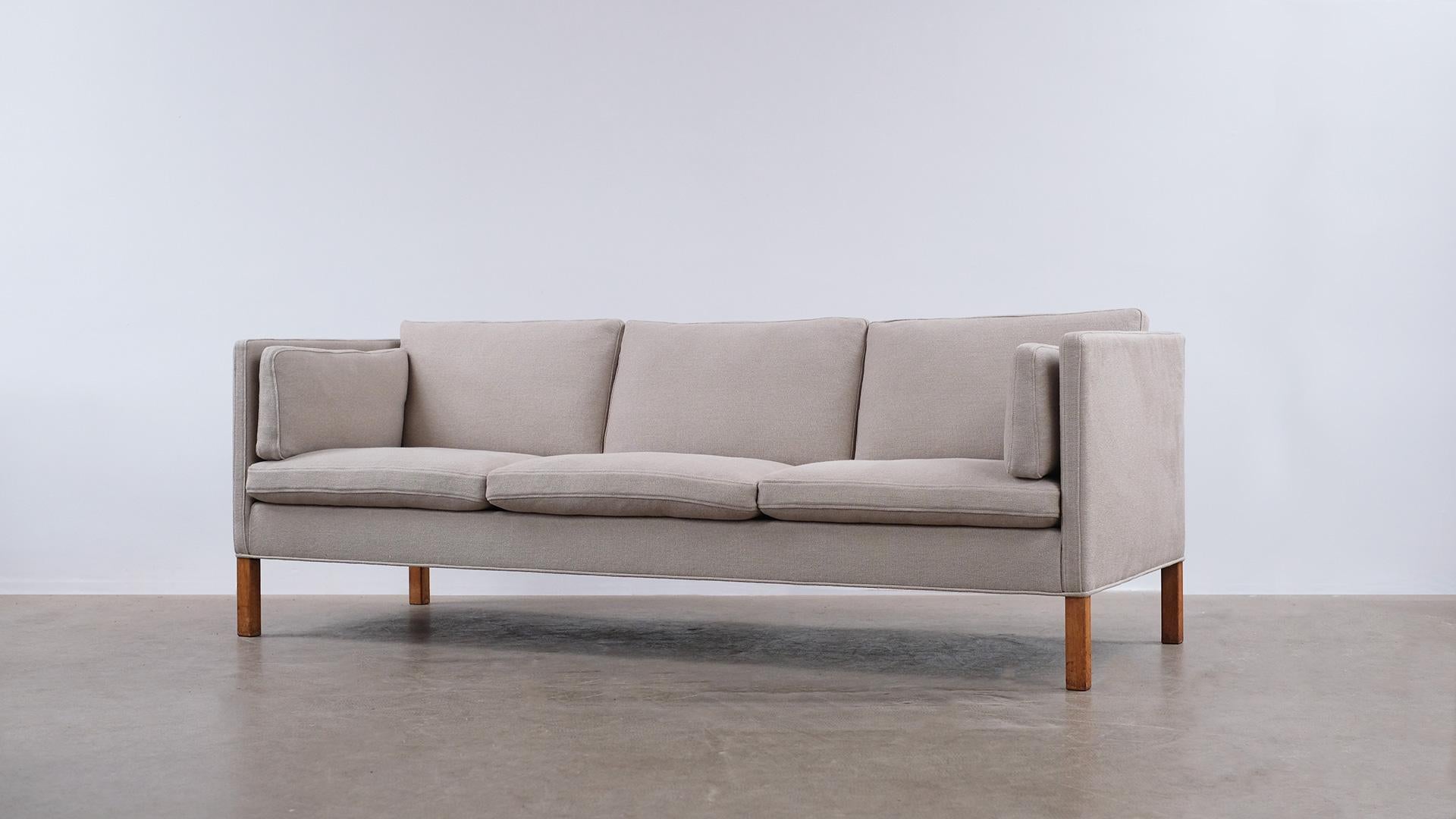 Wonderful classic 3-seat sofa, model 2443, designed by Børge Mogensen for Fredercia, Denmark. This example fully refurbished and reupholstered in beautiful heavy linen fabric by Kirkby Design. Ultra high quality and super comfortable with all down