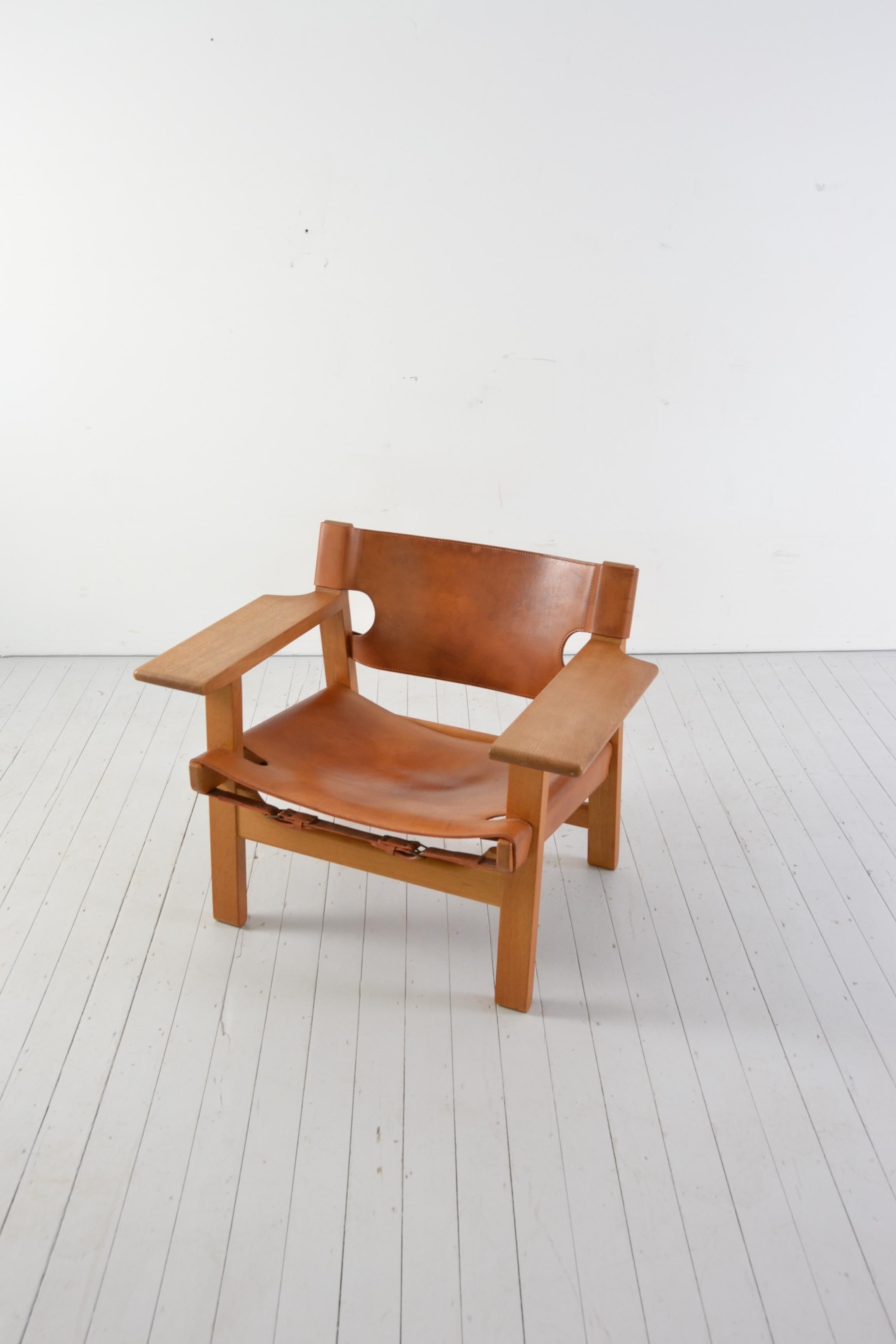 Iconic Borge Mogensen Spanish chair with nice patina. 

Thick cognac leather is exquisite with age; beautiful oak frame.