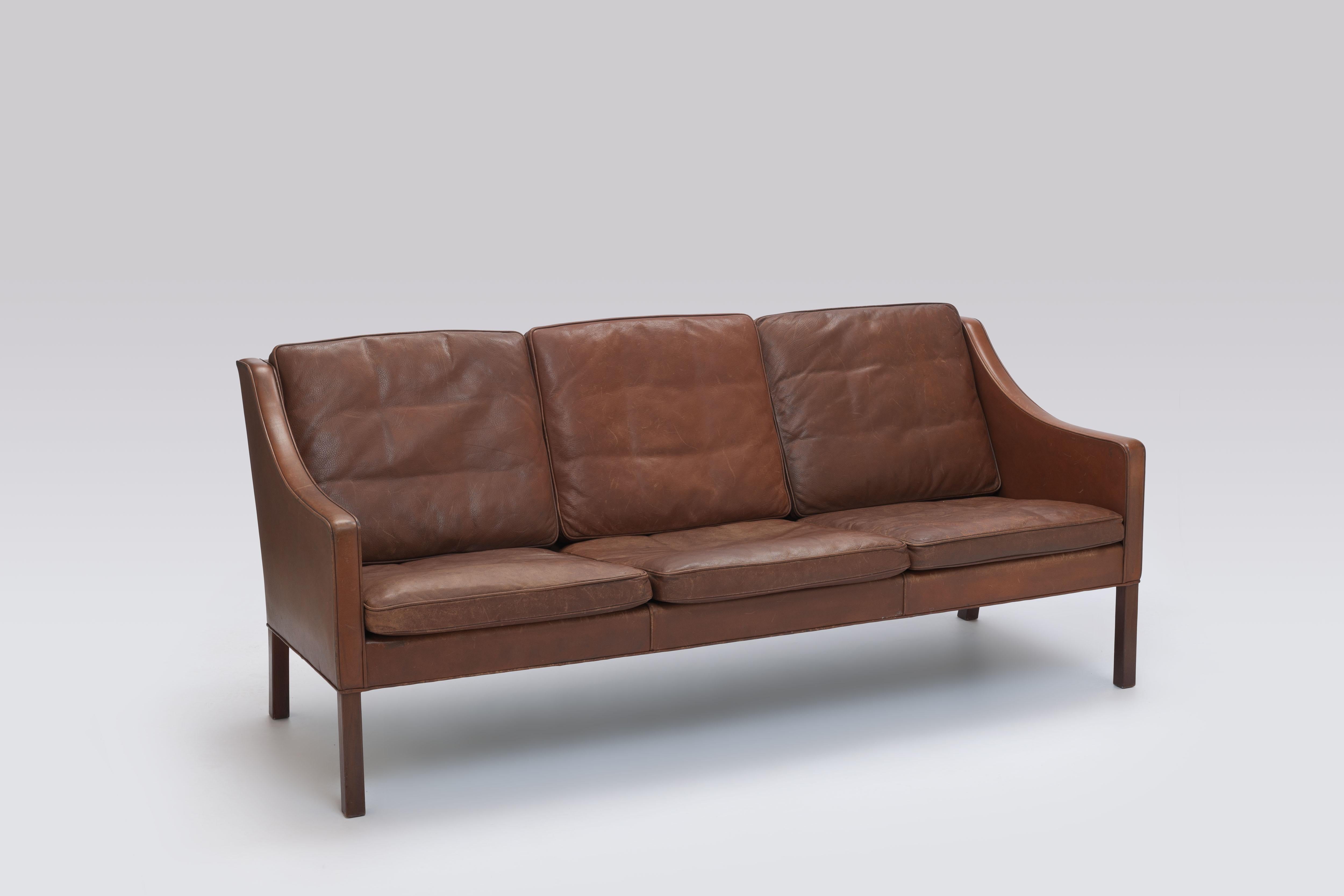 Iconic sofa model 2208 by Borge Mogensen in all original brown leather designed in 1963 executed by Fredericia in Denmark. 
This very high end manufactured sofa is very comfortable, due to down filled cushions, it's elegantly shaped and beautiful