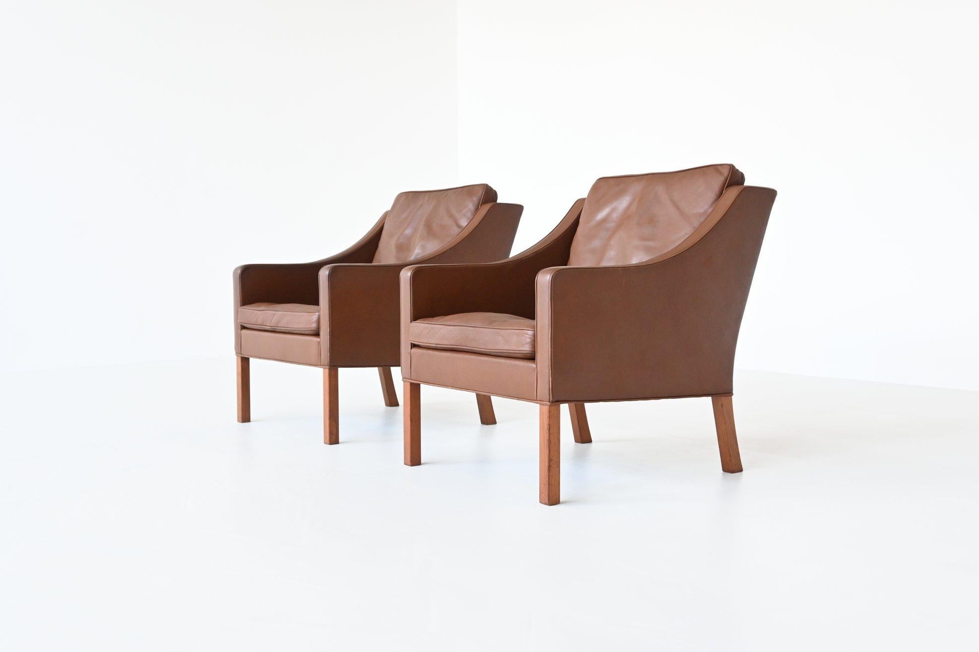 Beautiful pair of lounge chairs model 2207 designed by Børge Mogensen for Fredericia Stolefabrik, Denmark 1963. These chairs have high quality medium brown leather upholstery and solid teak legs. This set is quintessentially Danish; comfortable,