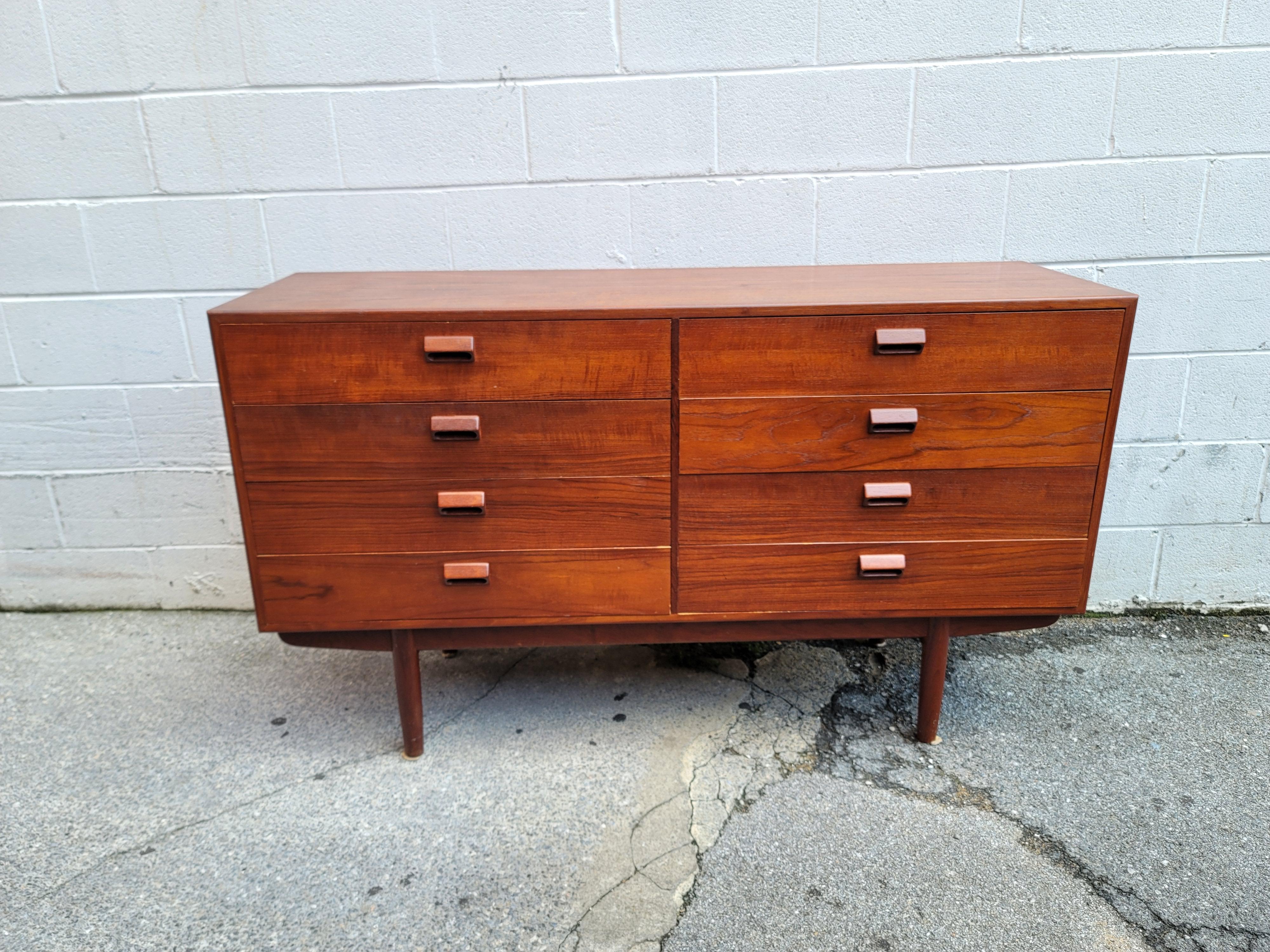 This Danish modern eight-drawer dresser was designed by Borge Mogensen for Soborg Mobler. The dresser was acquired from the family of the original owners and is in very good condition with little wear. The teak is beautifully aged with gorgeous