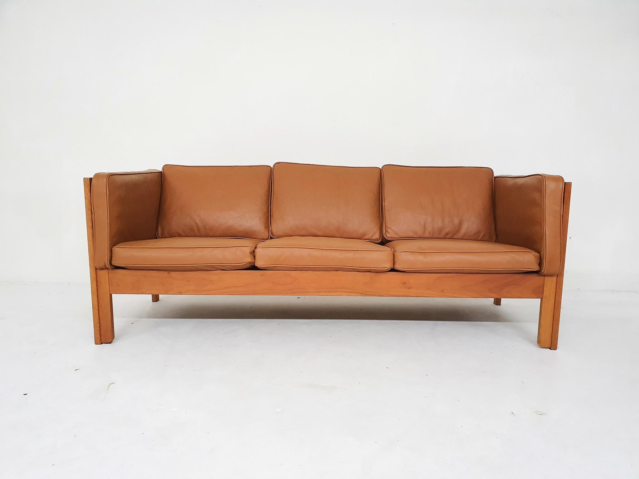 Wooden sofa with cognac leather cushions. Designed by Borge Mogensen for Fredericia.
With new cognac leather upholstery. The wooden frame is in good condition, only a sratch on the back.
The sofa is marked inside the cushions.