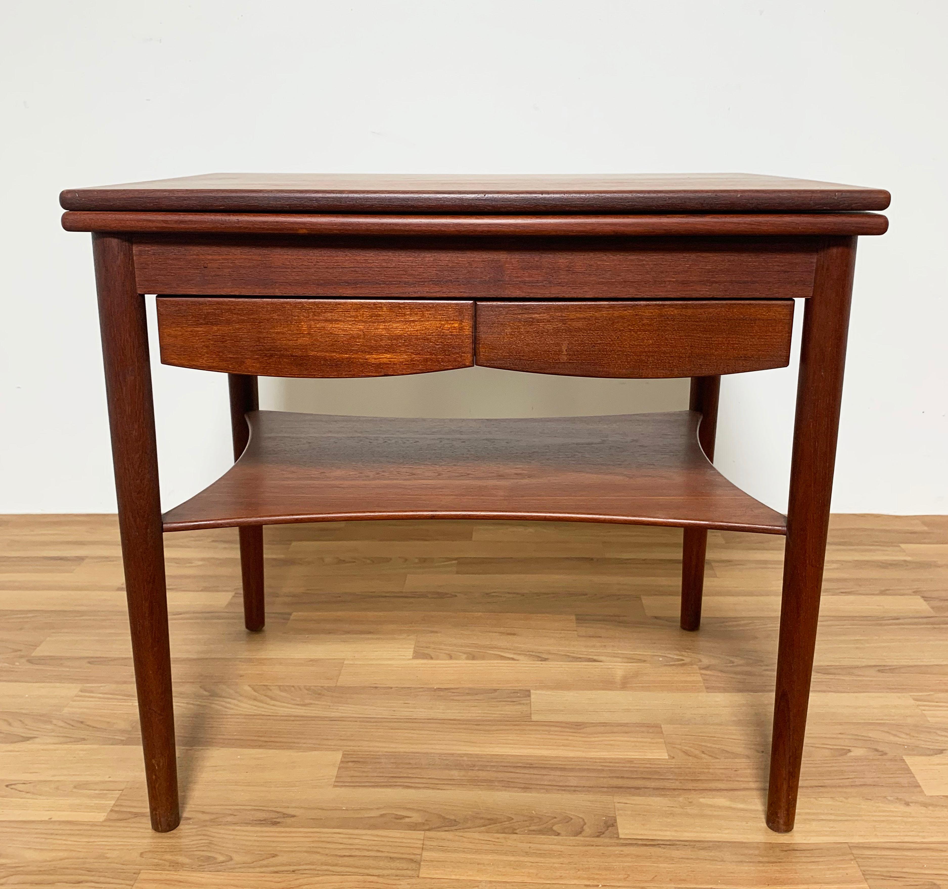 A rare teak side table with flip top and under-drawers, Model 149, designed by Borge Mogensen for Soborg Mobelfabrik, Denmark, ca. 1950s.
In the closed position, this measures 26