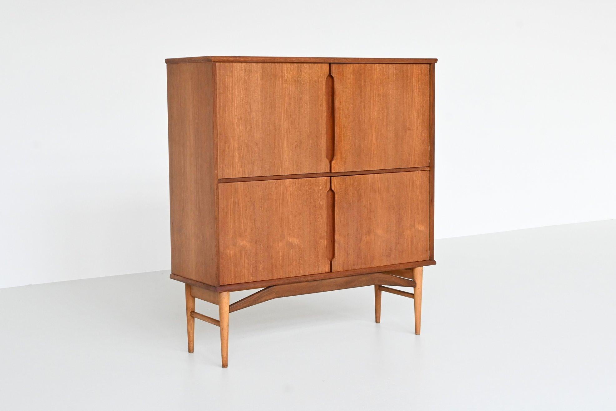 Wonderful Danish highboard designed by Borge Mogensen and manufactured by Fredericia Stolefabrik, Denmark 1960. This beautiful cabinet is made of veneered teak with solid beech legs. It has four doors with three shelves behind and offers plenty of