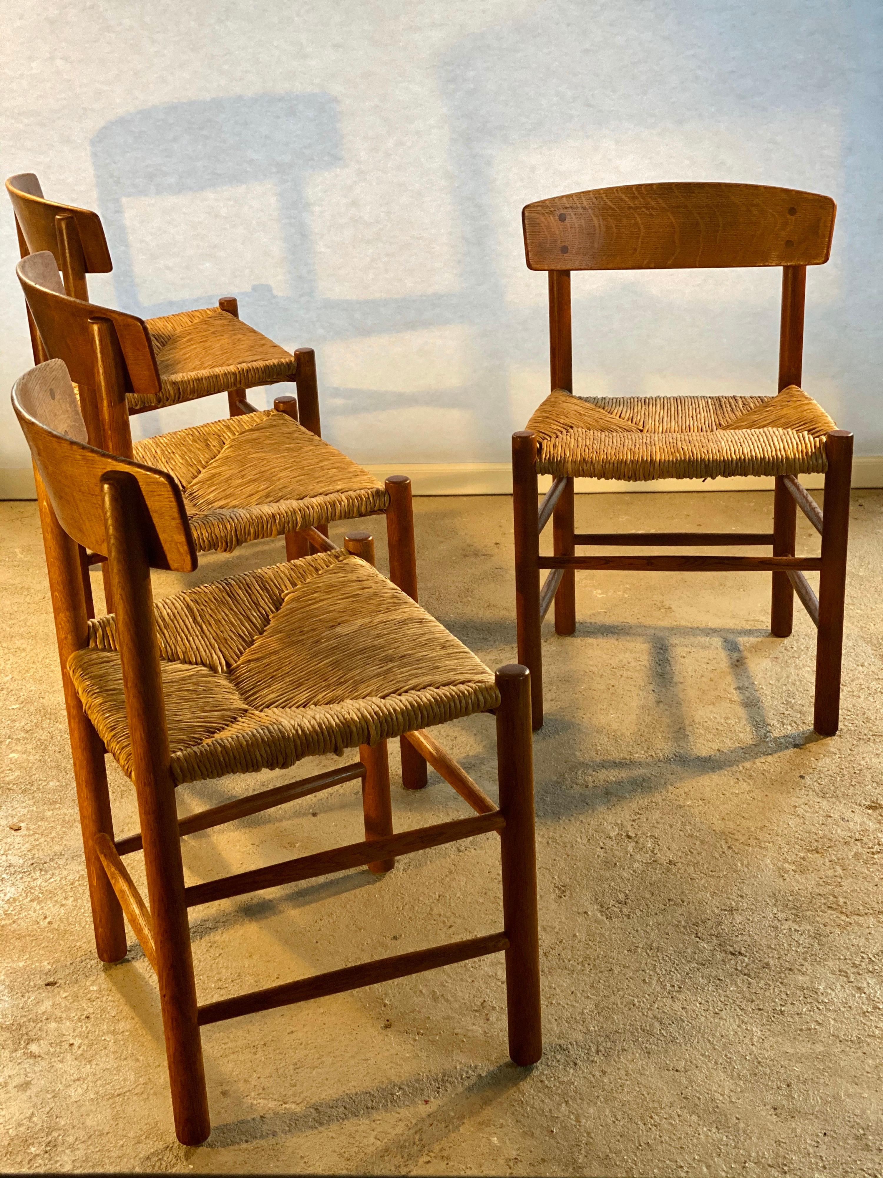 A set of all-time Classic midcentury design dining room chairs model J39 by Danish designer Børge Møgensen. These chairs are from the very rare, very first 1947 edition manufactured by Federicia, in solid oak and with the original rush seat (so no