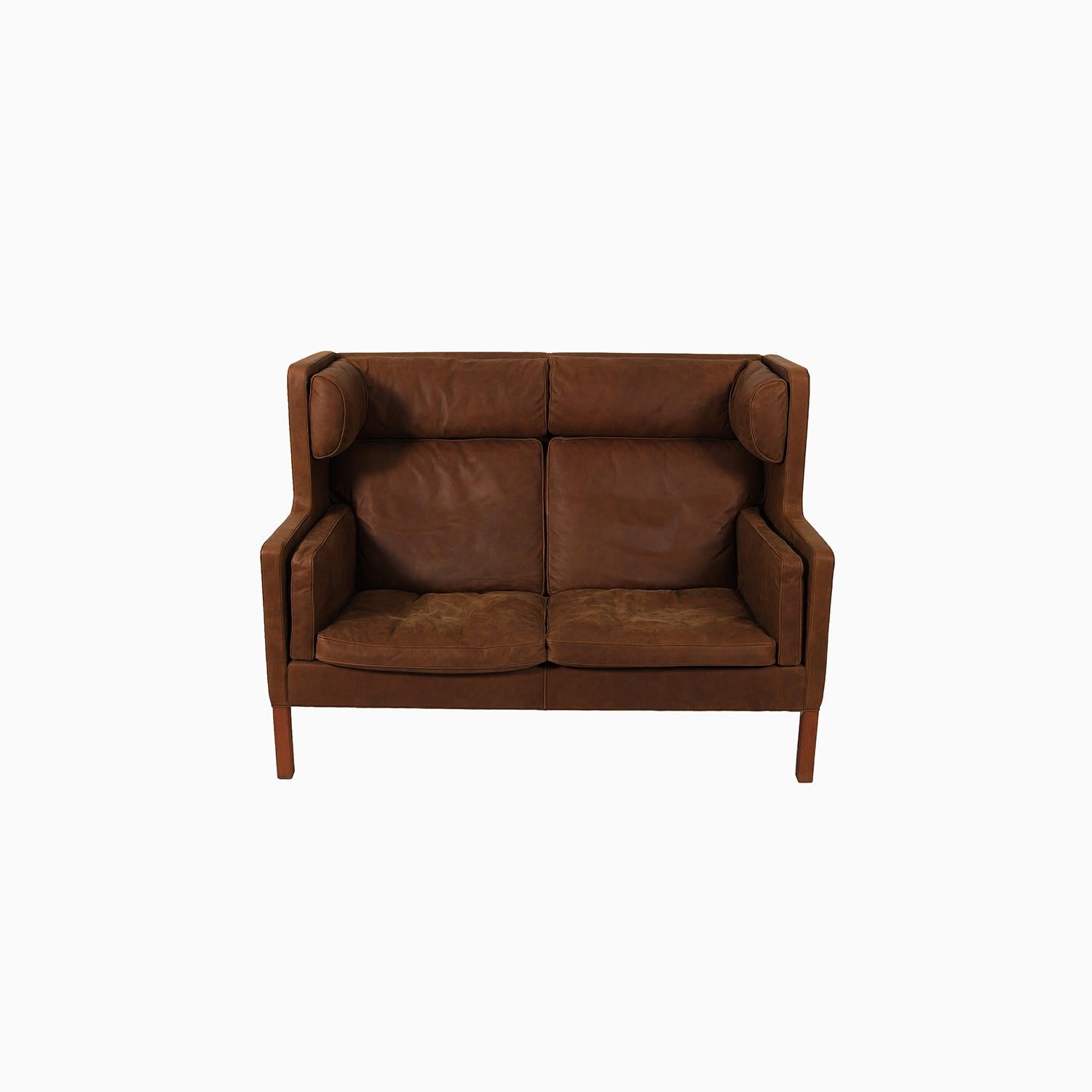 Melt into this extremely comfortable two seat sofa designed by Borge Mogensen for Fredericia furniture. Known as the Kupe sofa. This two seater was recently restored in a soft supple leather with down feather inserts. A perfect place to find