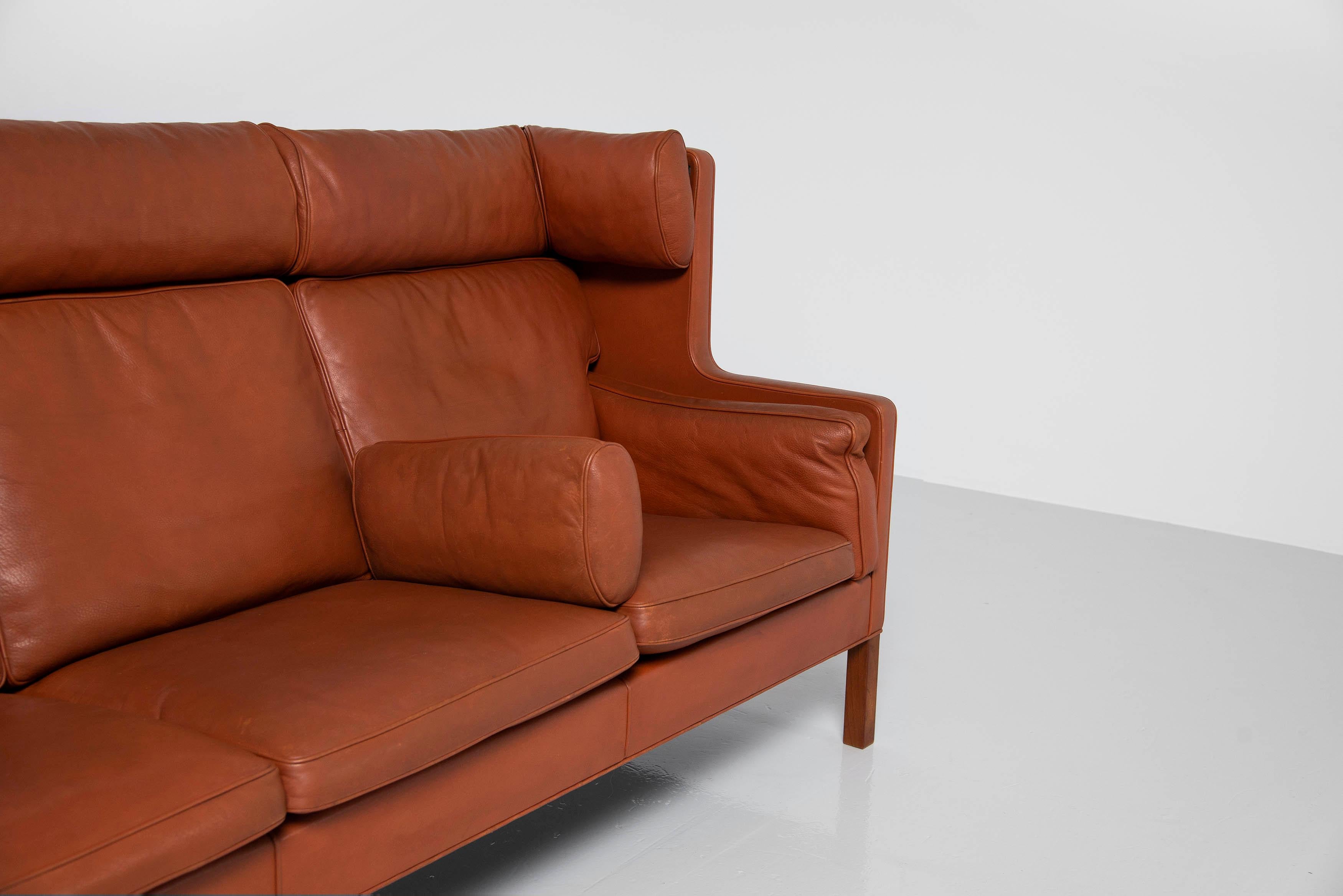 Stunning wingback sofa model 2193 designed by Borge Mogensen and manufactured by Fredericia Stolefabrik, Denmark 1965. This sofa has solid teak wooden legs and beautiful cognac leather with minimal patina from age and usage. The sofa has nice bent