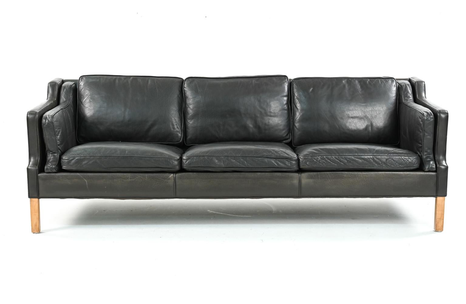 An impressive Danish mid-century leather four-seater sofa designed by Borge Mogensen.