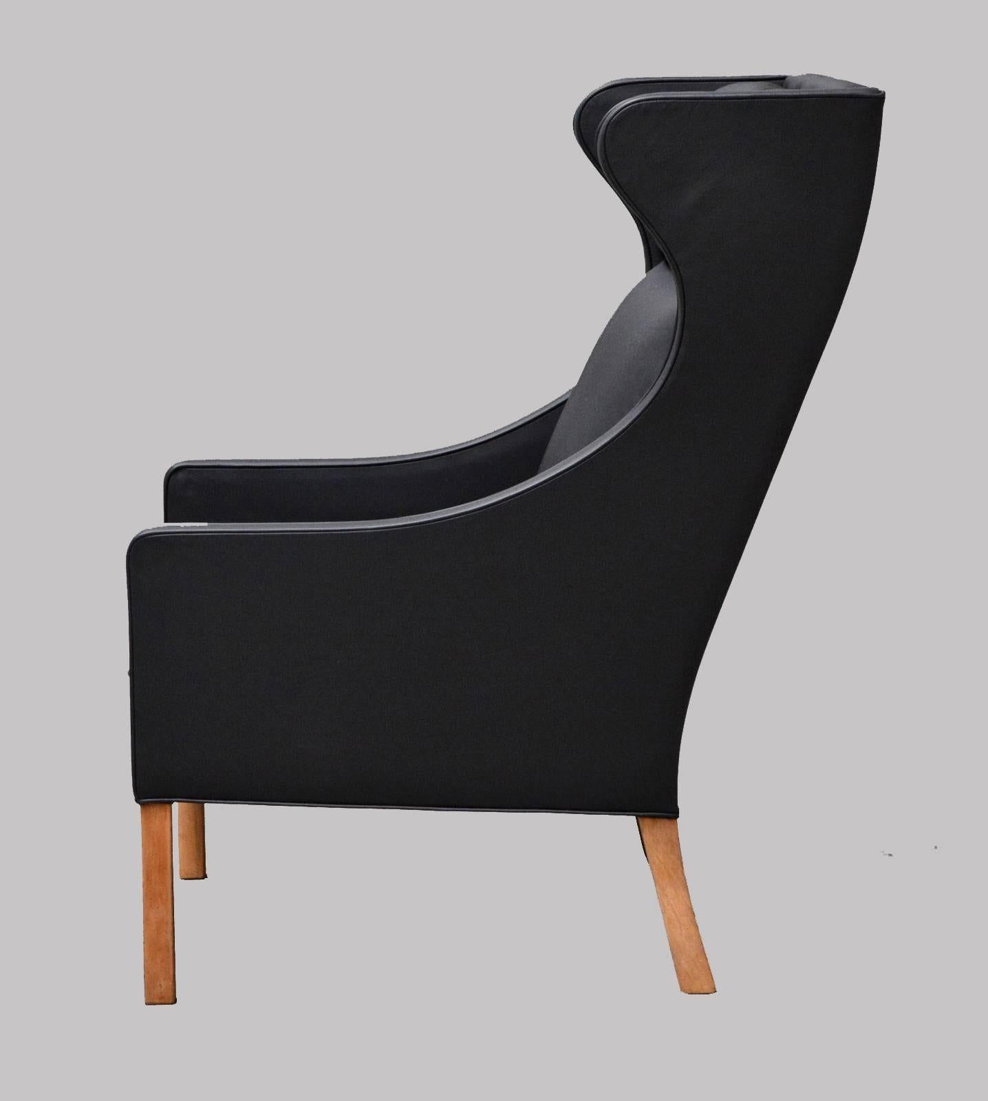 This model 2204 wingback easy chair was designed by Børge Mogensen in 1963 and produced by Fredericia Stolefabrik in Denmark during the late 1960s. The chair is in very good original condition apart from the head support pillow that has been covered