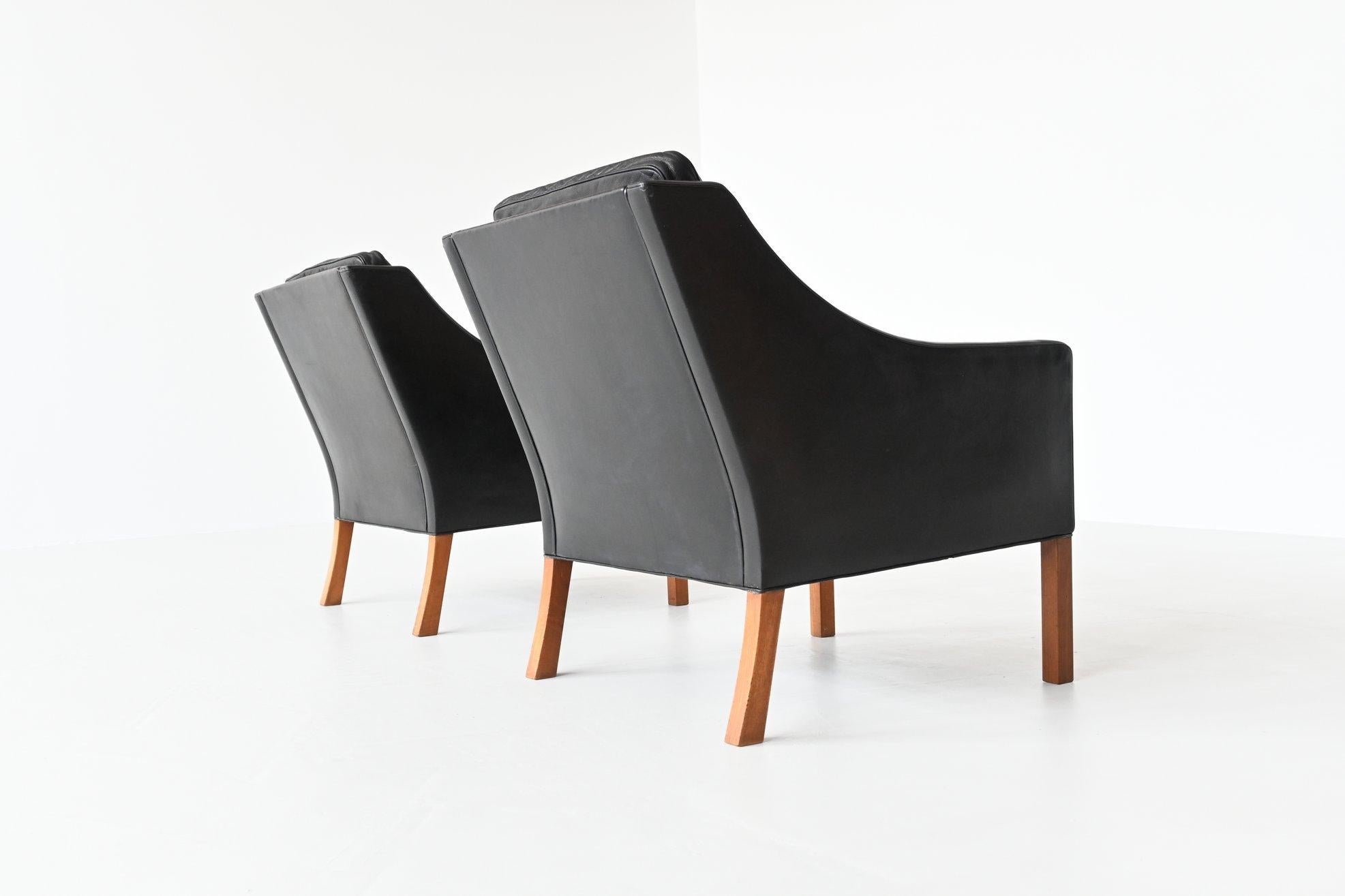 Beautiful piair of lounge chairs model 2207 designed by Børge Mogensen for Fredericia Stolefabrik, Denmark 1963. These chairs have high quality black leather upholstery and solid teak legs. This set is quintessentially Danish; comfortable, well made