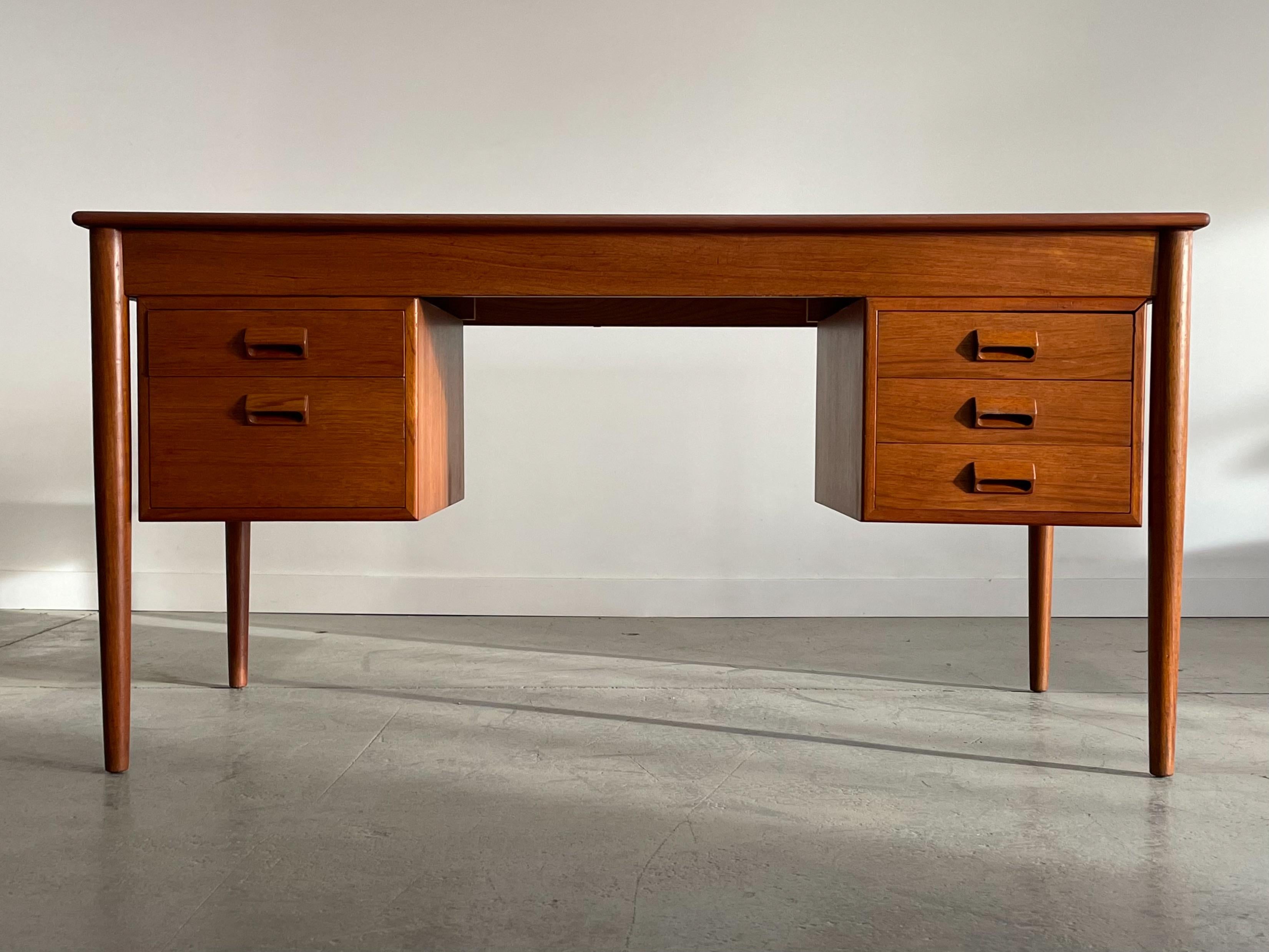Stunning teak writing desk designed by Borge Mogensen for Soborg Mobler. This piece features a simple, yet elegant design characteristic of Mogensen furniture. Also typical of Mogensen's work is premium construction considered detailing throughout.