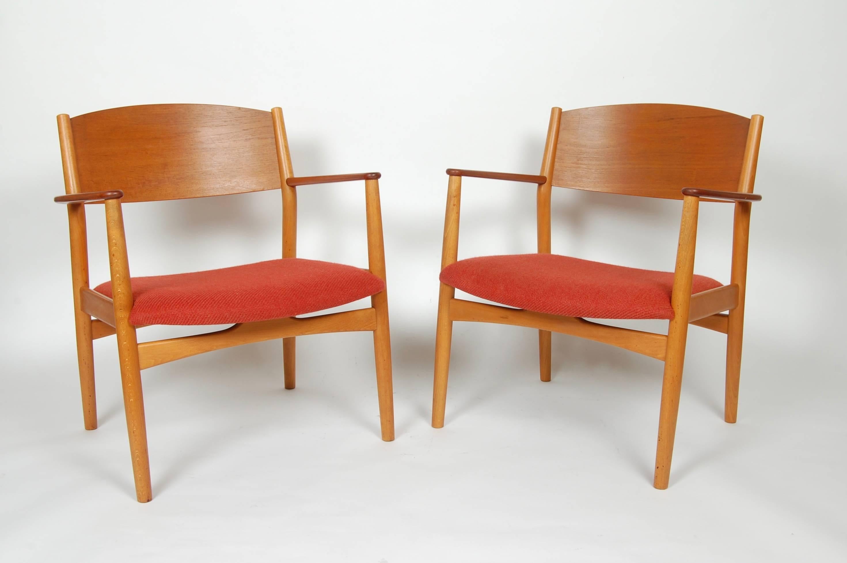 Early 1950s production Borge Mogensen model 147 armchairs. Created out of a mixture of teak and beechwood. Wide seat and back for comfort, wool rust colored upholstered seats.