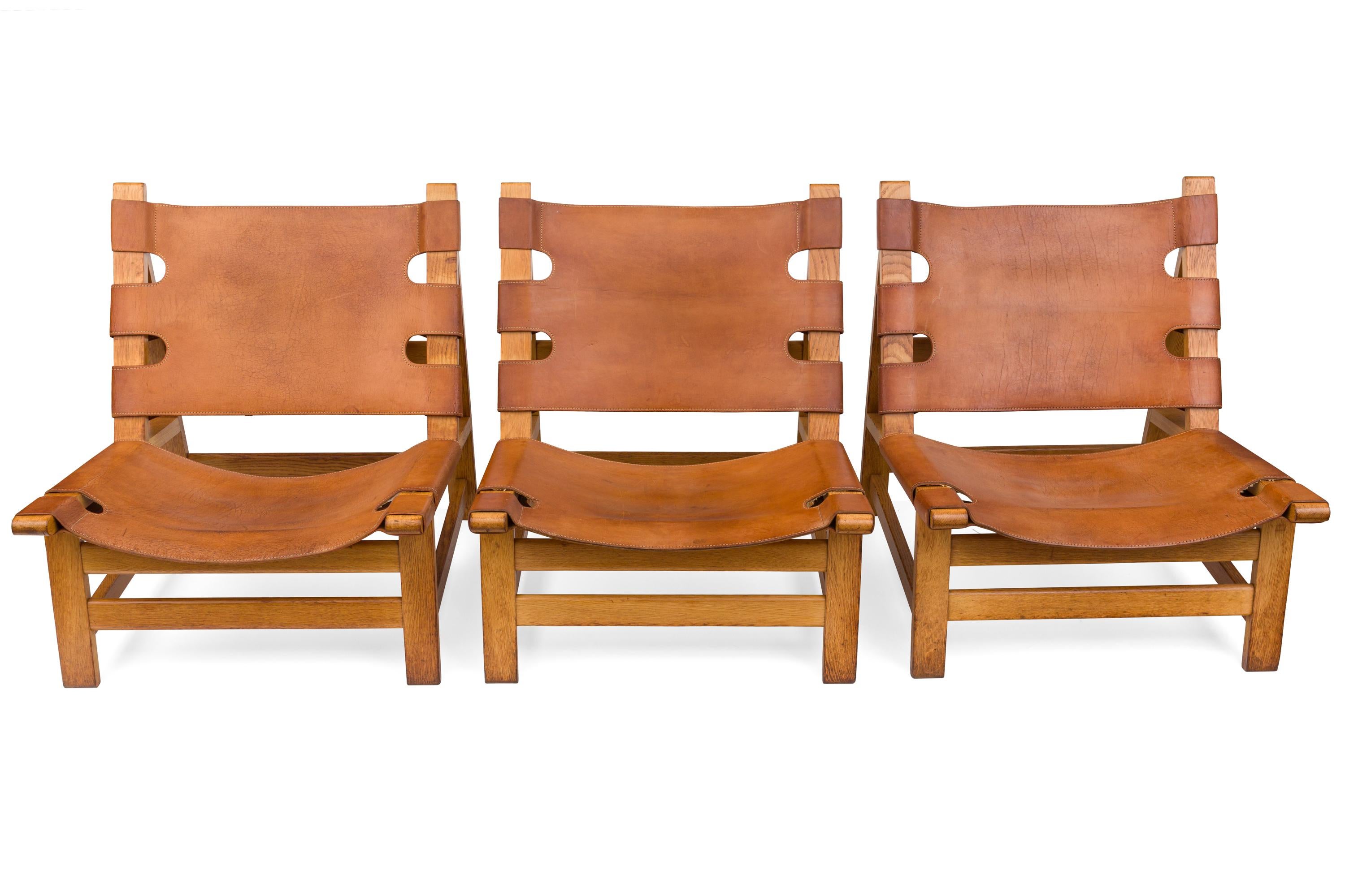 A rare set of low lounge chairs with frames of solid oak. The seat and back with patinated brown grain leather. These examples were manufactured by Fredericia Stolefabrik.  Two of the chairs in the listing were sold, there are four remaining for
