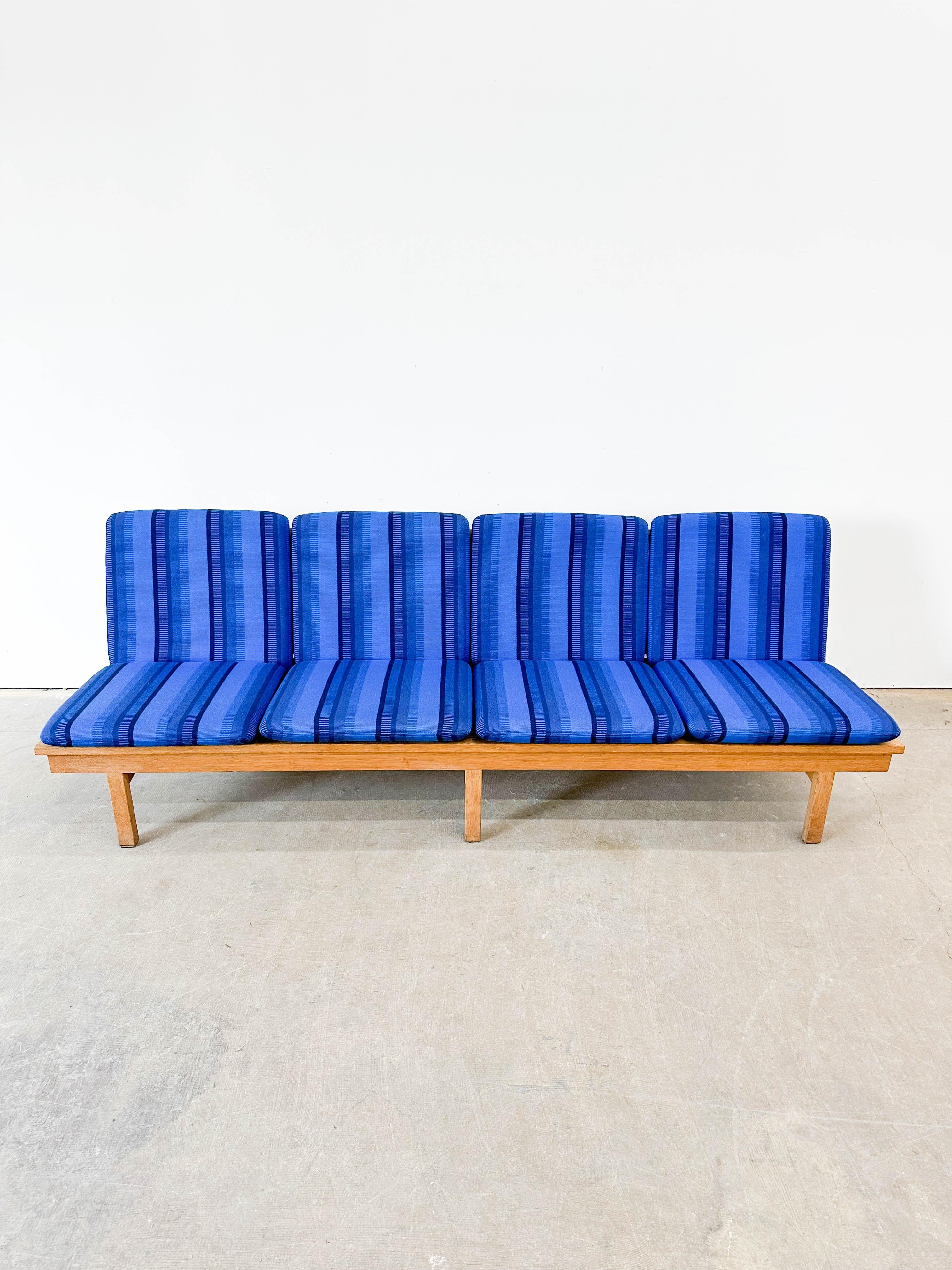 Superb four seat solid oak sofa model 2219 from Danish designer Borge Mogensen. Made by Fredericia Stolefabrik in the 1960s, this example has fantastic original wool cushion covers in a classic Scandinavian stripe pattern. The sofa frame looks great