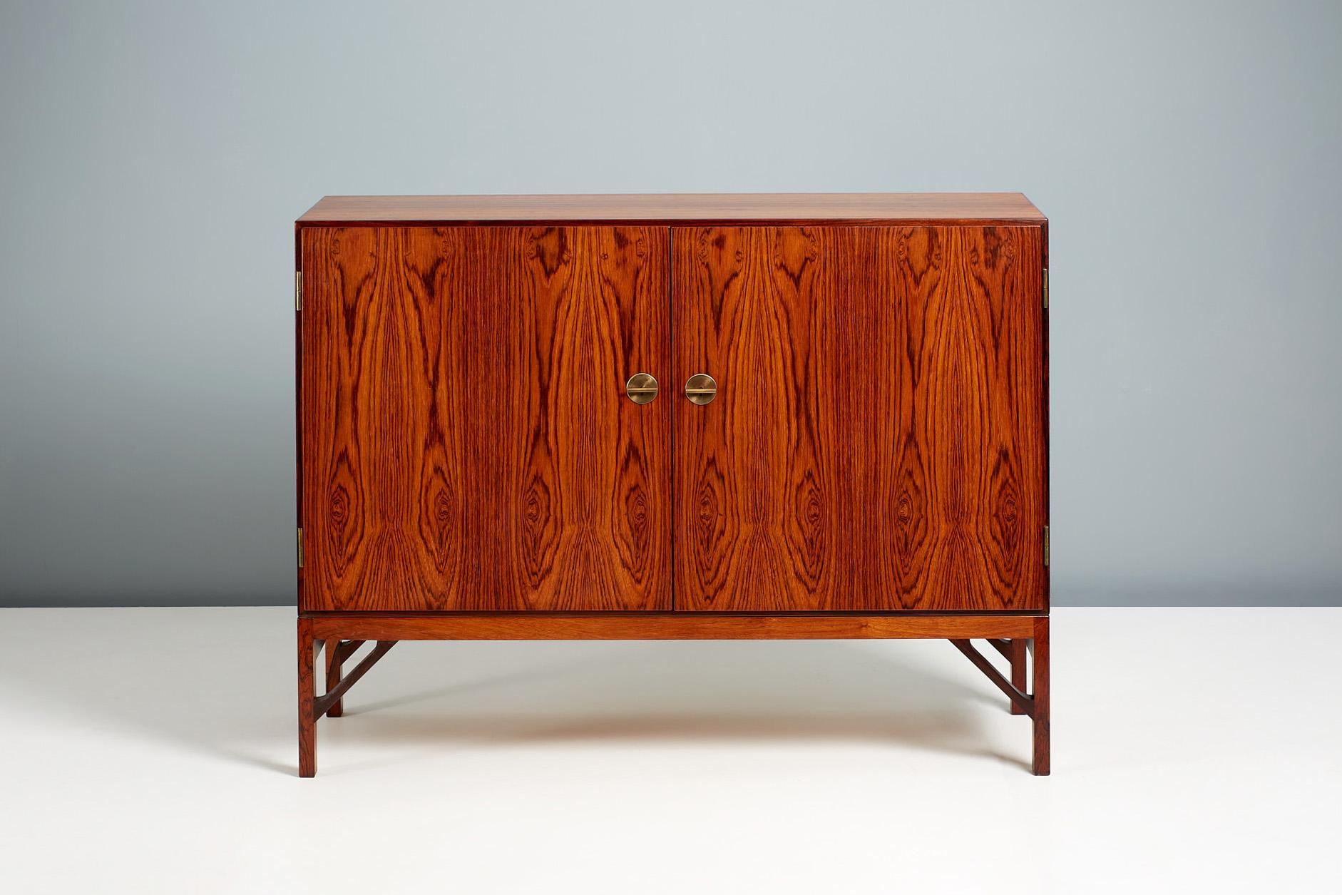 Borge Mogensen - Model A 232 Cabinet

Rarely seen rosewood version of Mogensen's iconic cabinet design. The front has two doors with Chinese style decorative brass T-Bar keys. The interior is lined with Maple wood veneer and solid maple shelves and