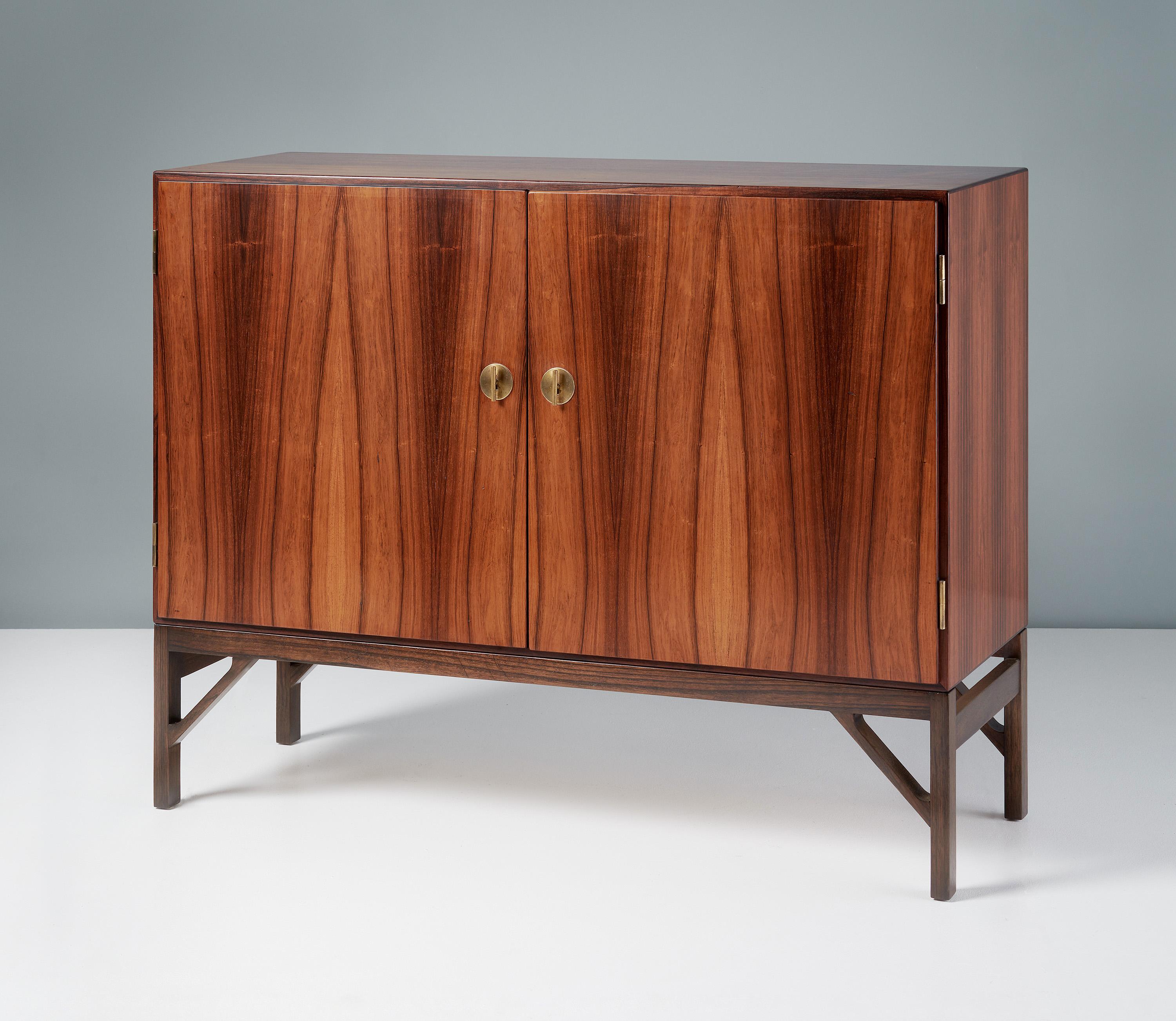 Borge Mogensen - Model A 232 Cabinet

Rarely seen rosewood version of Mogensen's iconic cabinet design. The front has two doors with Chinese style decorative brass T-Bar keys. The interior is lined with Maple wood veneer and solid maple shelves and