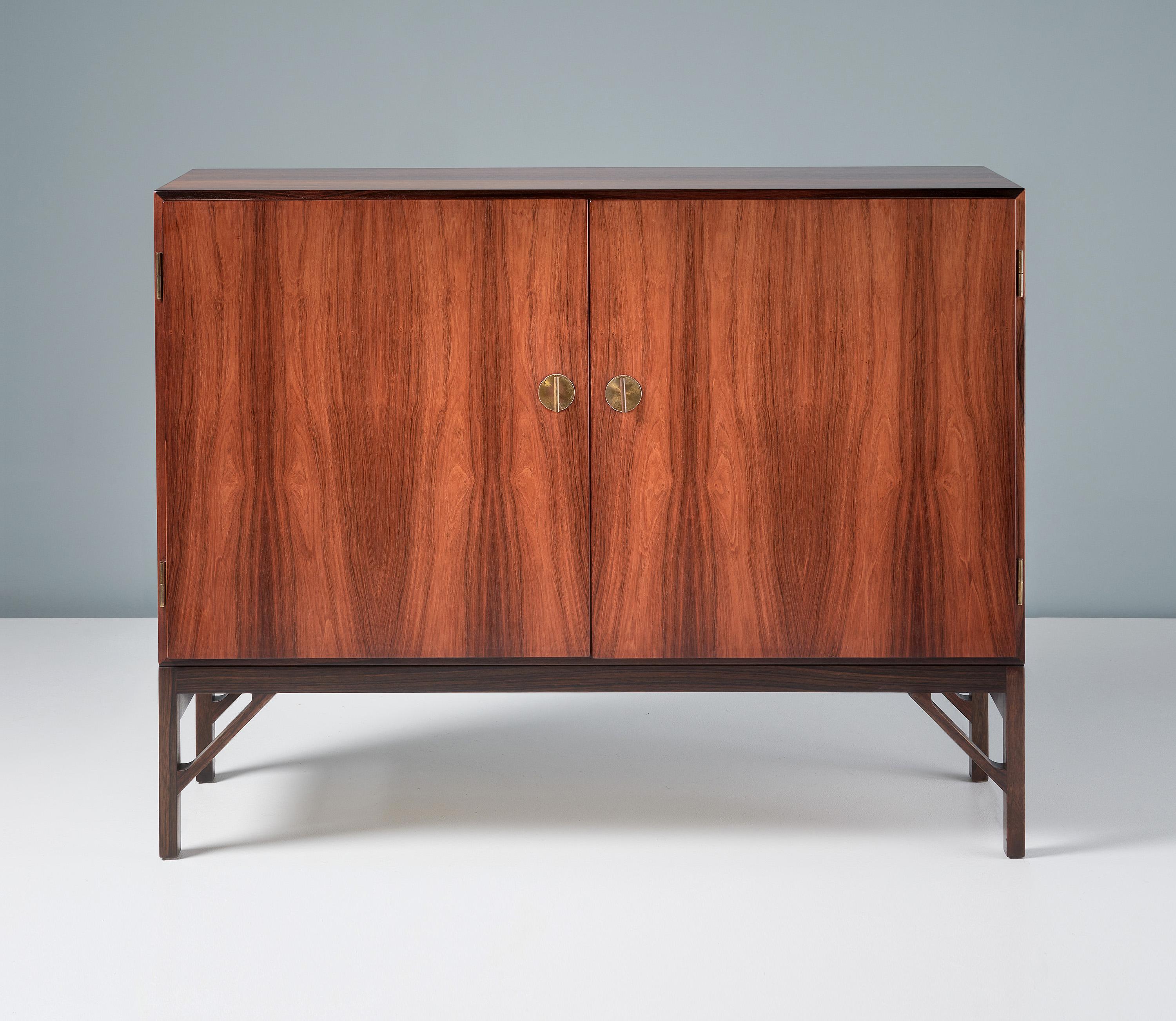 Borge Mogensen - Model A 232 Cabinet

Rarely seen rosewood version of Mogensen's iconic cabinet design. The front has two doors with Chinese style decorative brass T-Bar keys. The interior is lined with Maple wood veneer and solid maple shelves and