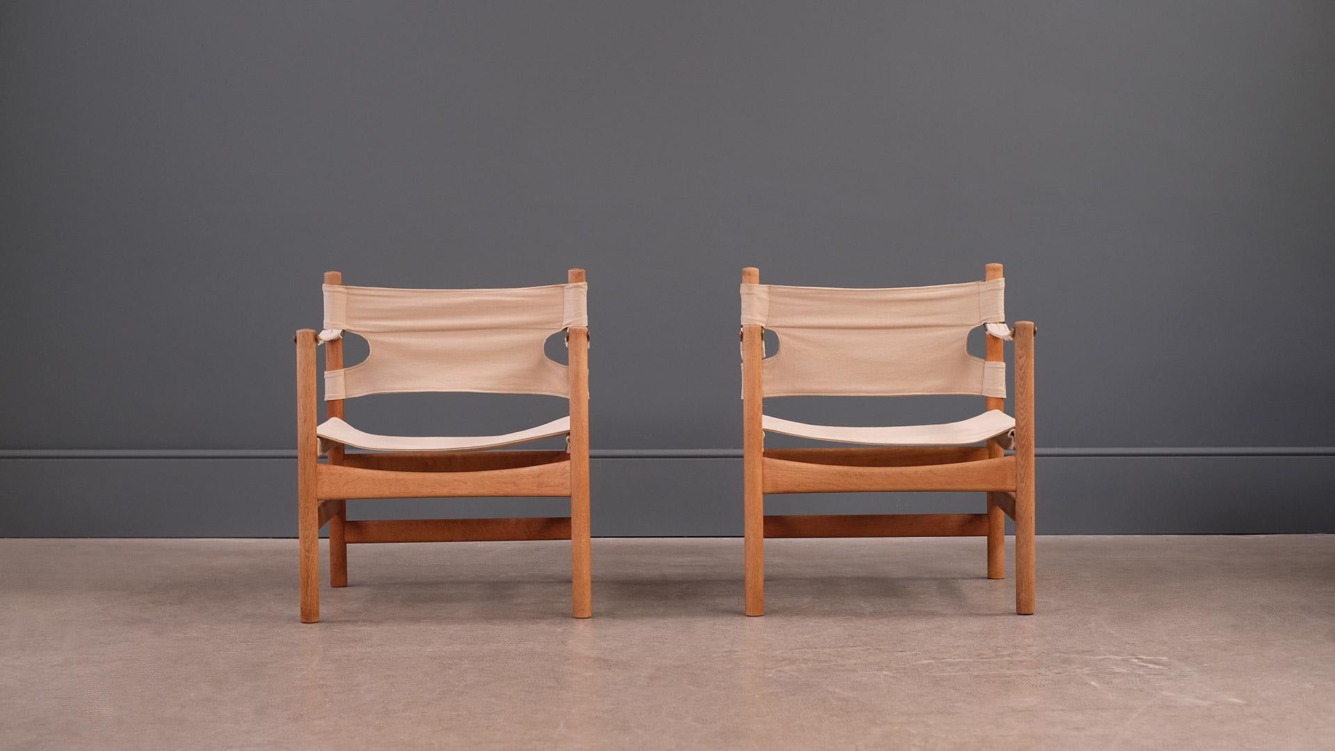 Very beautiful pair of Safari chairs in solid oak and brass with original slung cotton canvas seats designed by Borge Mogensen for Fredericia, Denmark. Rarely seen very high quality chairs and super comfortable too.