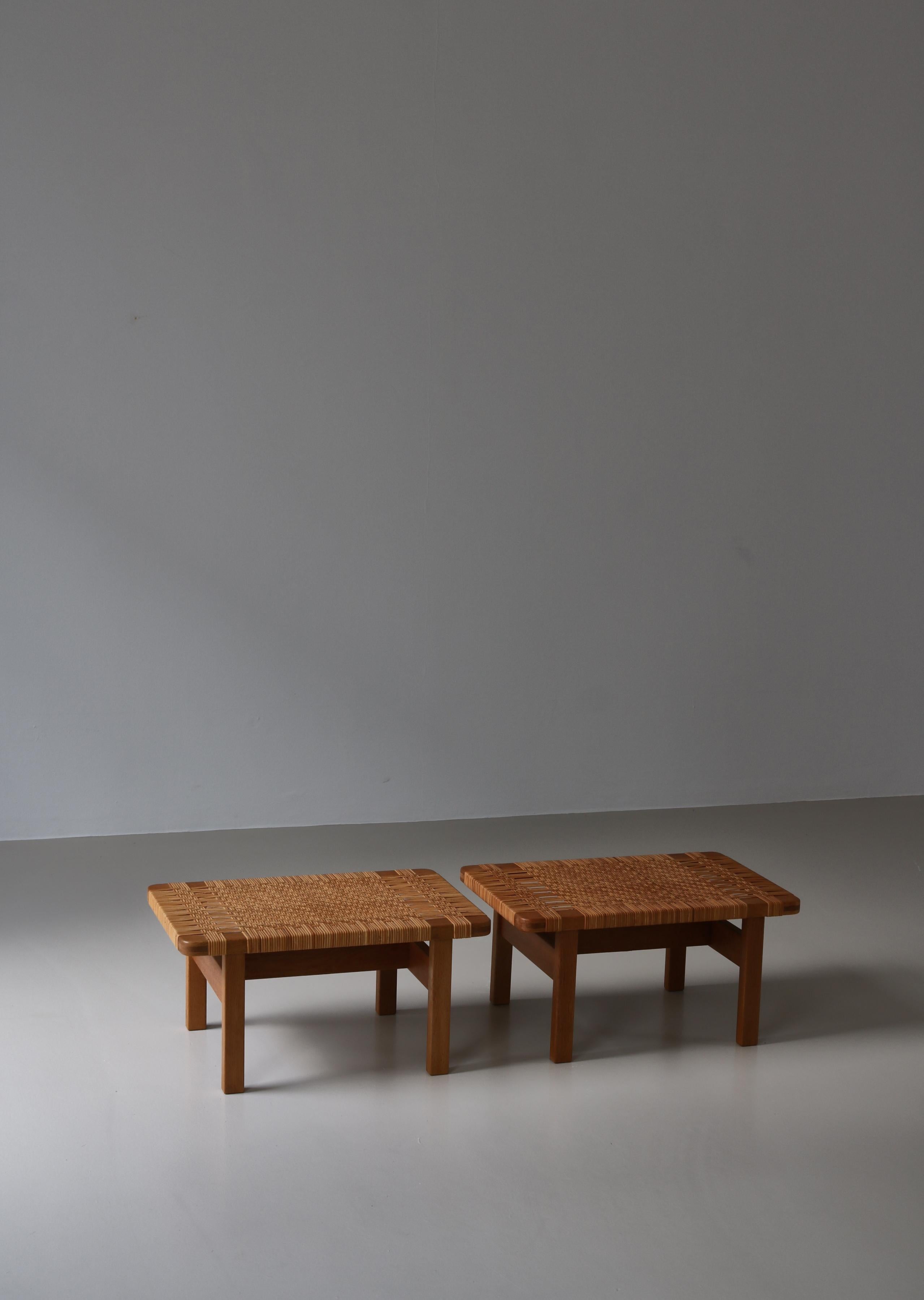 Amazing set of Danish modern side tables or benches in solid oak and handwoven rattan cane by Danish architect Borge Mogensen. Mogensen designed this model in the 1950s when it was made in different sizes by Fredericia Stolefabrik, Denmark. This