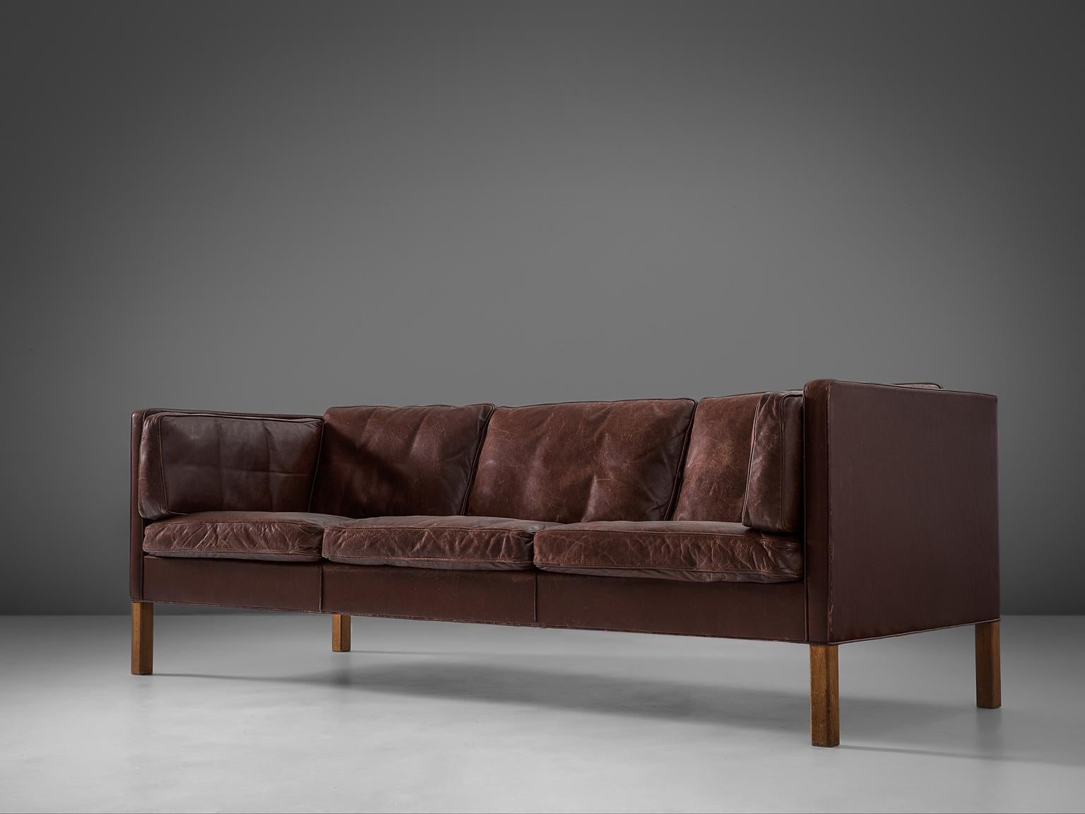 Børge Mogensen for Fredericia Stolefabrik, sofa model 2443, leather and oak, Denmark, 1960s.

This design comes from the 1960s and has wonderful shapes and comfort. The three-seater sofa comes with loose cushions in seating, back and sides. They