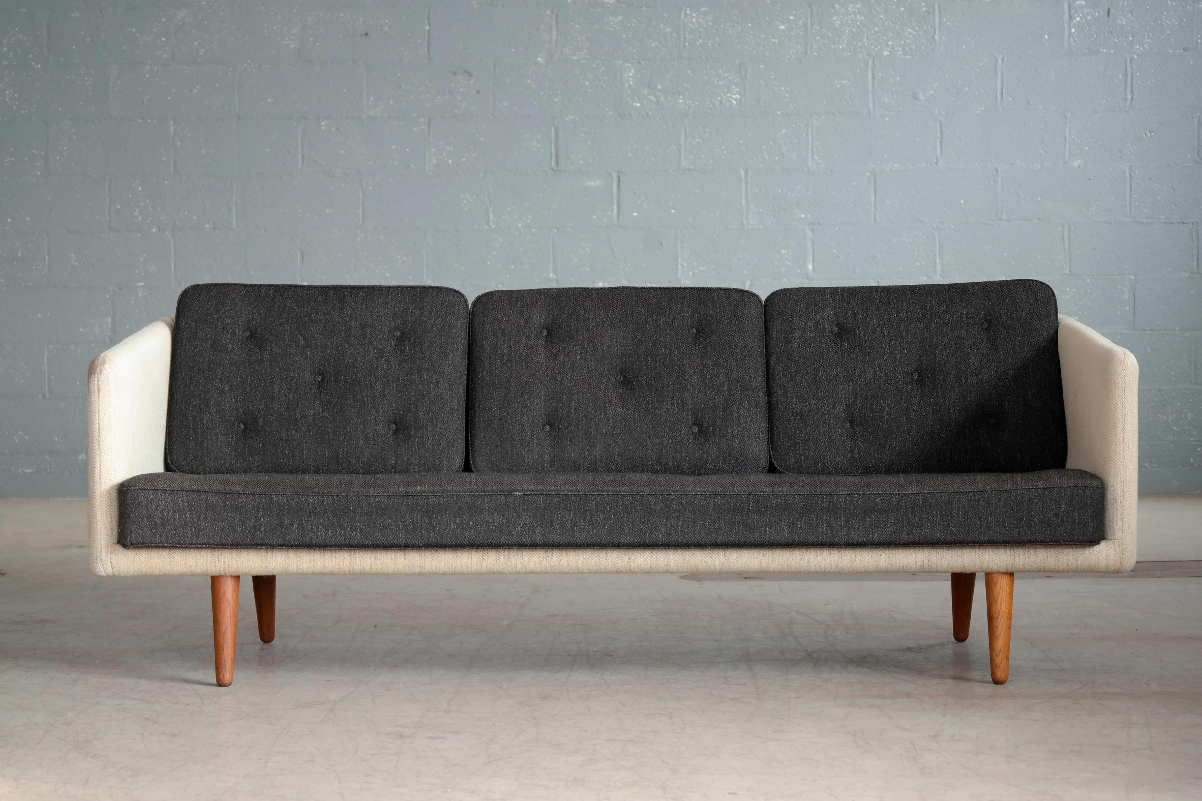 This fantastic sofa was designed by Borge Mogensen in 1955 as model 203 for Fredericia Stolefabrik and manufactured sometime between 1955 and 1960. In period fashion, Mogensen used loose cushions for this sofa, which would be precedent for his later