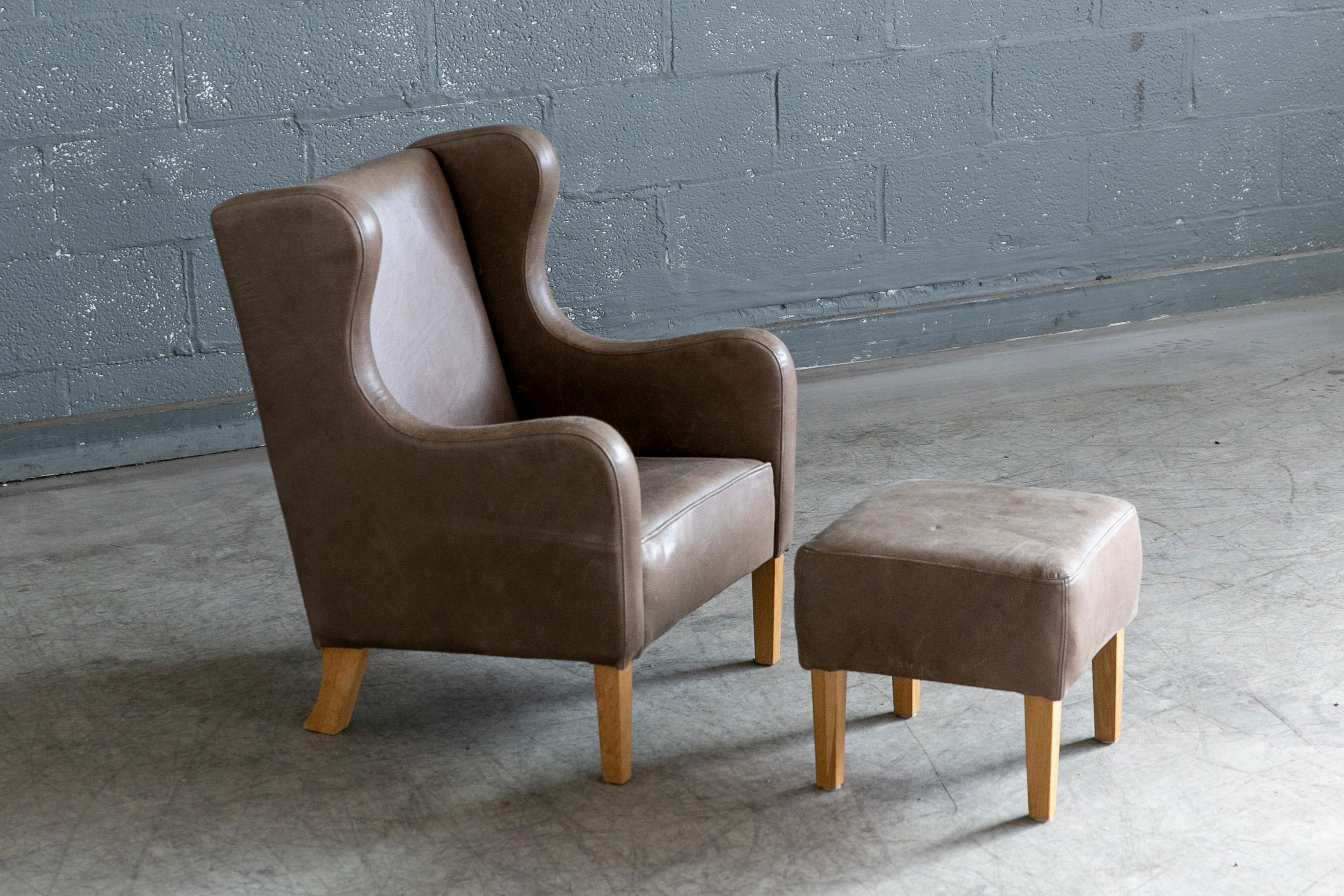 Super cute and charming children's wingback chair with ottoman in the style of Borge Mogensen's famous furniture. Made from supple leather and beech wood. Perfect for the stylish living room where this childrens furniture won't clash with or