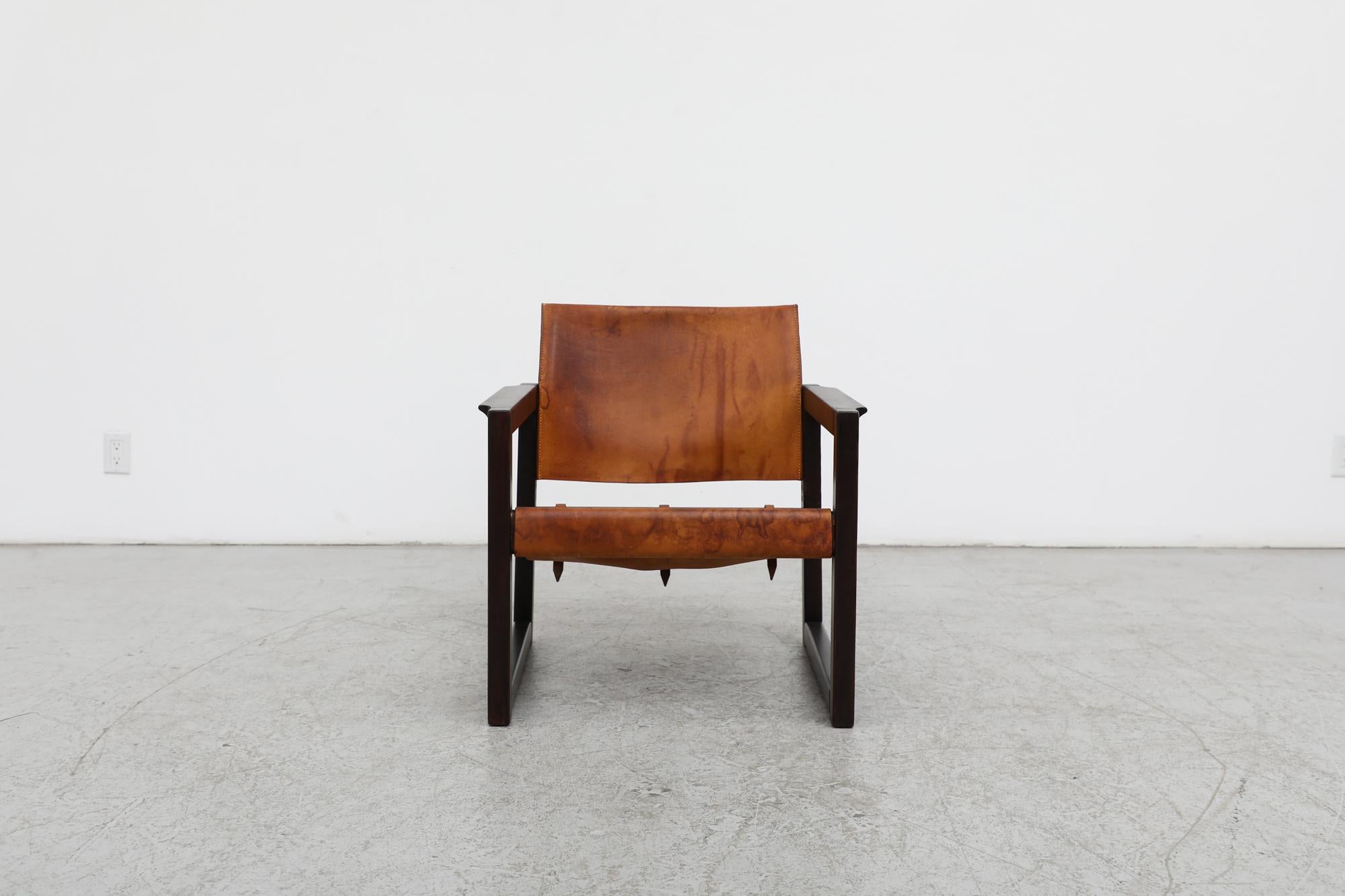 Beautiful Borge Mogensen/Kaare Klint style mid-century leather and dark stained pine safari chair by Swedish designer Karin Mobring. Mobring built off (and updated) the Cikada by designer Bengt Ruda from a decade earlier , in the process making it