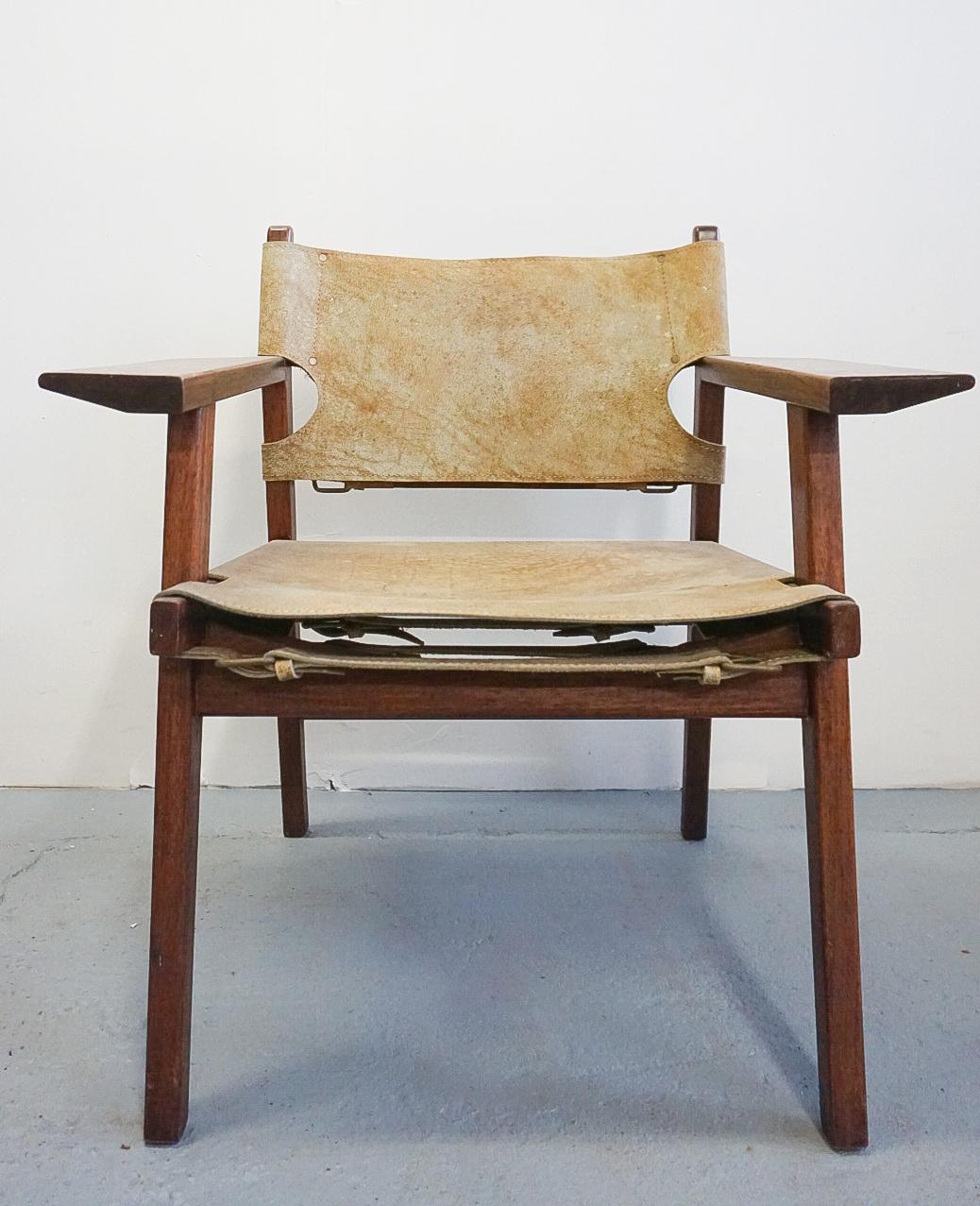 Beautifully crafted vintage chair very similar to Borge Mogensen's 'Spanish chair'. The frame is solid Mahogany and sling is thick suede cowhide, suspended with brass buckles.

The frame is in excellent condition, very sturdy and superb oiled