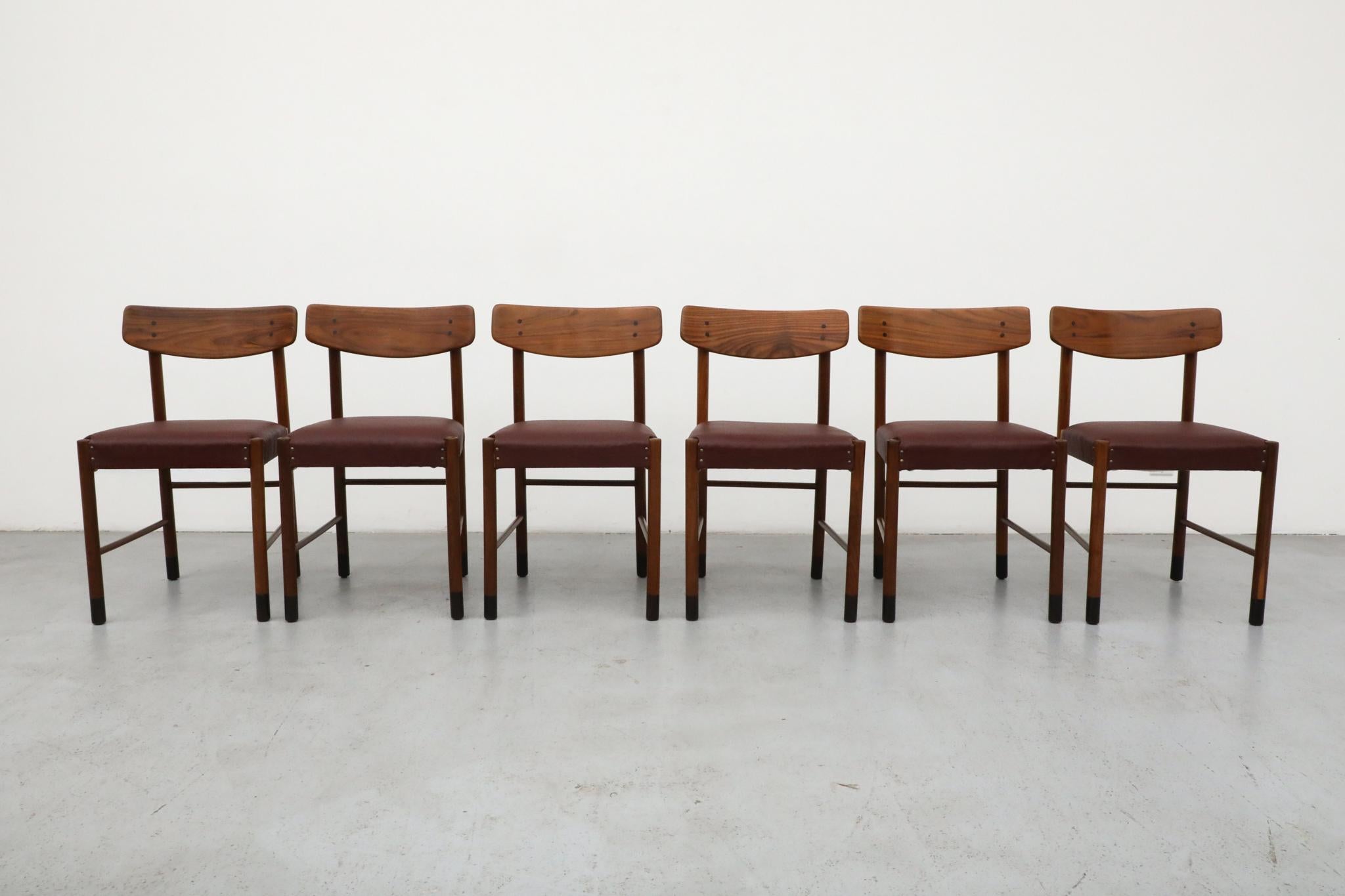 Set of 6 Mid-Century teak dining chairs with curved backrests and skai seats inspired by the work of Danish design great Børge Mogensen.  This attractive set of dining chairs have beautiful grain pattern and burgundy seats that deliver a warm mix of