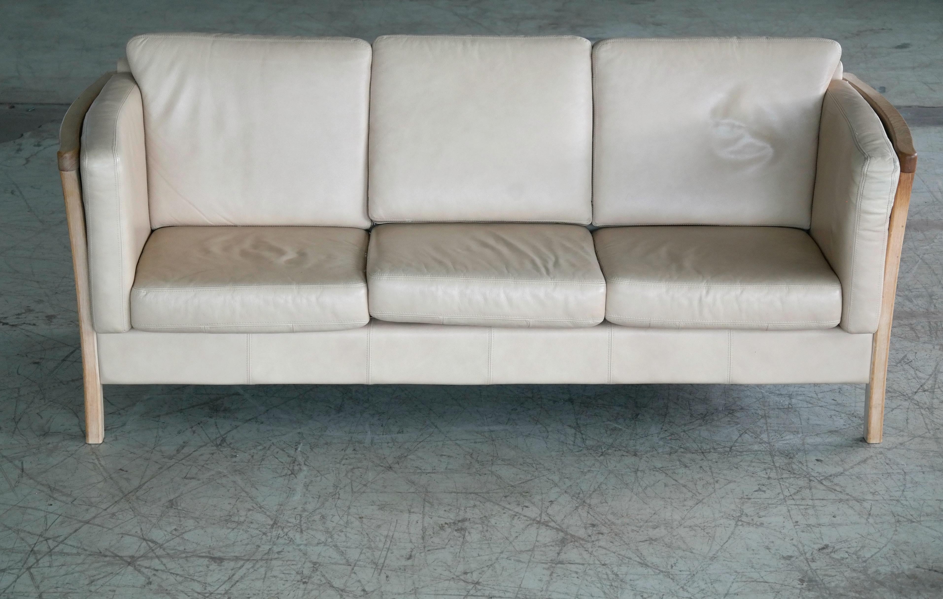 Great Danish modern sofa in the tradition of Borge Mogensen's famous spoke back sofa. It is an enduring design that the Danes have appreciated for many decades as they love the mix of leather and blond wood. The sofa is un-marked and we are not
