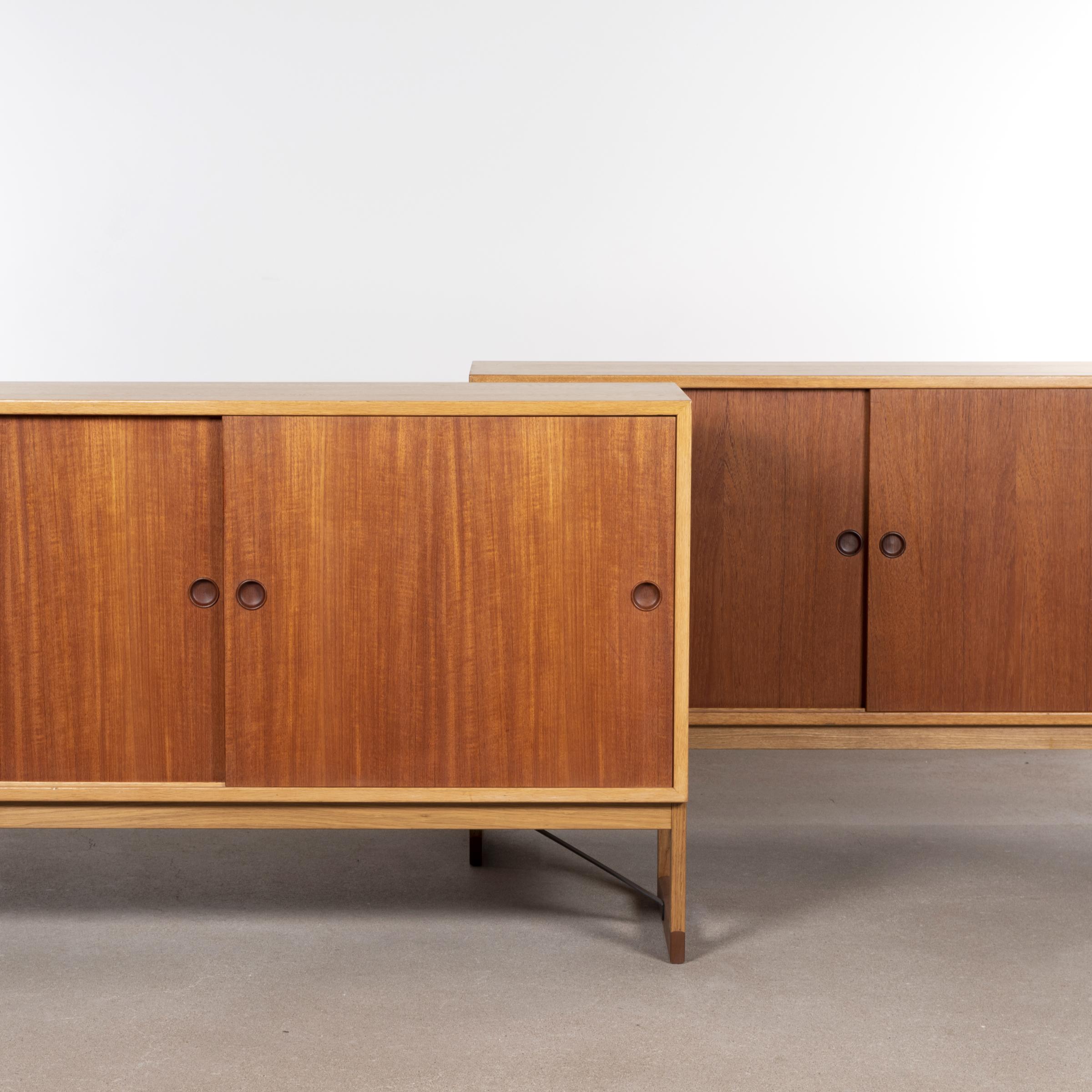 Elegant cabinet by Børge Mogensen for Karl Andersson & Söner. Oak corpus with Teak sliding doors (both directions) and glides. Shelves can be moved as required. All in good vintage condition with minor traces of use. A matching set is available.