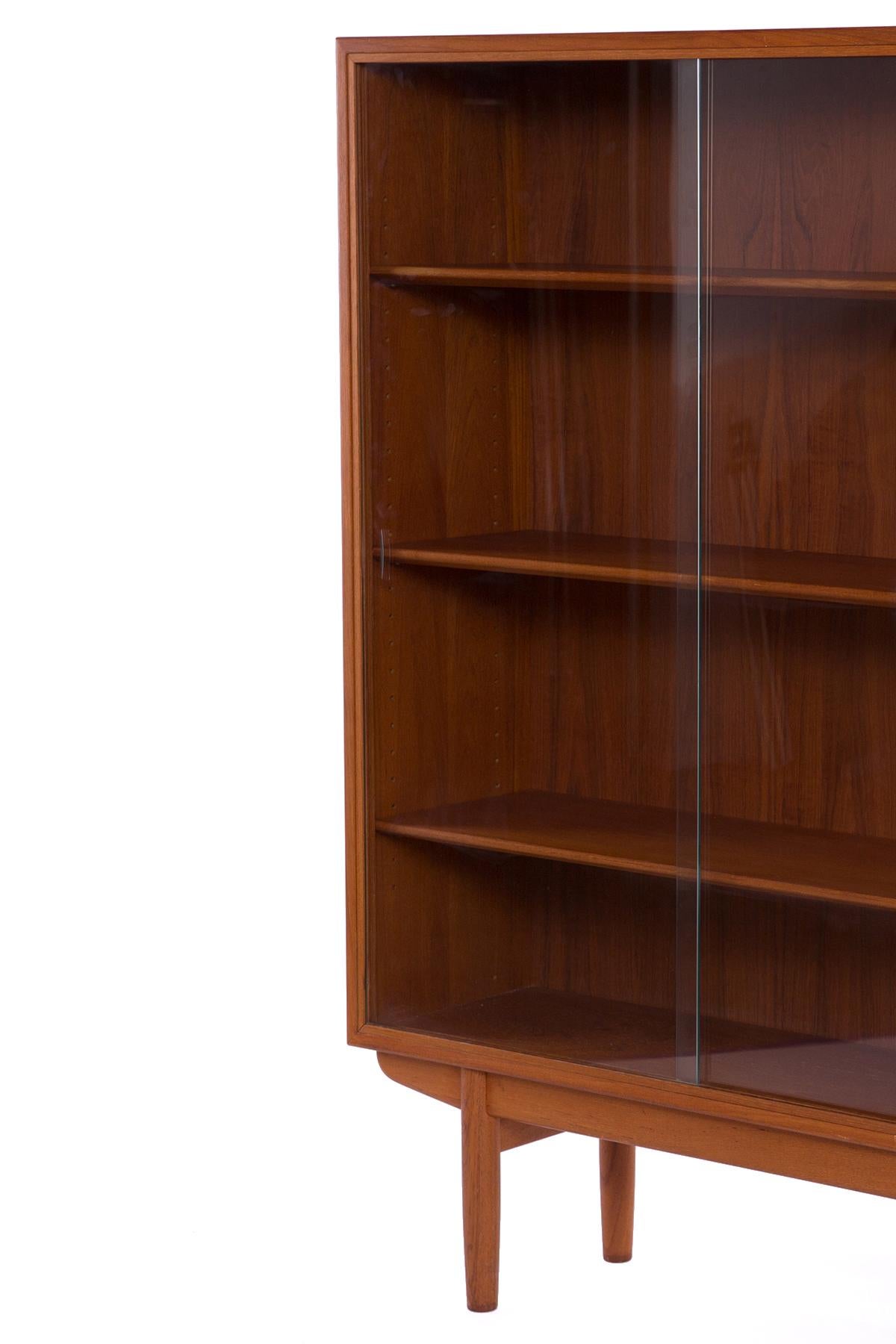 Borge Mogensen teak and glass book case early circa 1960s. This all original example has three shelves and two glass sliding doors and is in fabulous original condition.