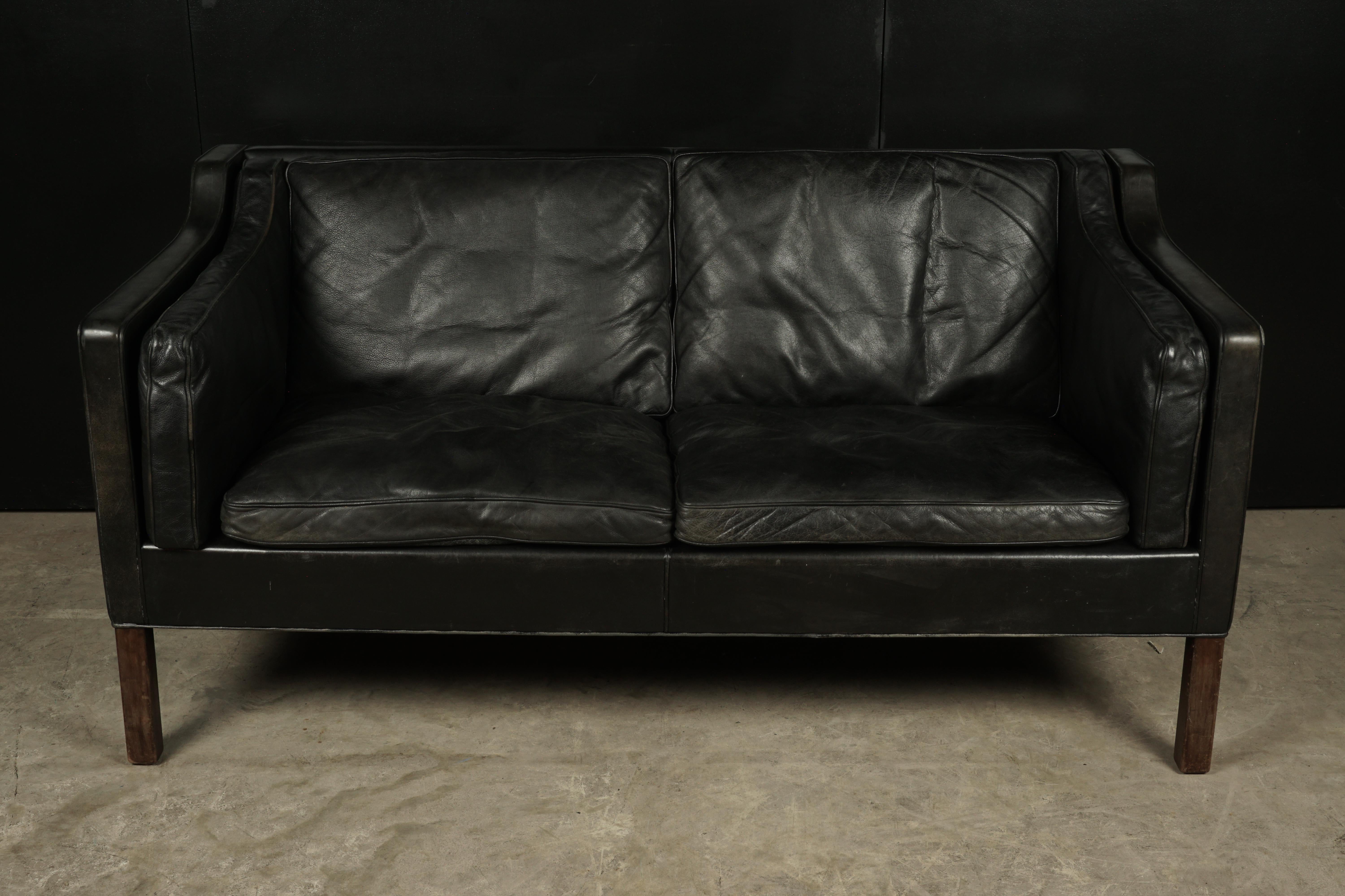 Borge Mogensen two-seat sofa, model 2213 from Denmark, circa 1970. Original black leather upholstery with very nice wear and patina.