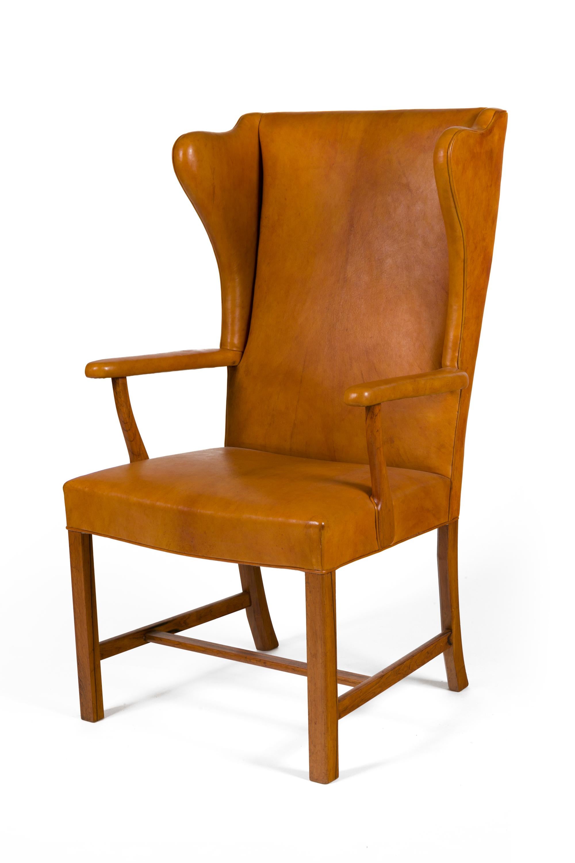 An extraordinarily rare and wonderful chair. Although similar in design to many of his wing chairs this chair has open arms that create a particularly graceful effect.