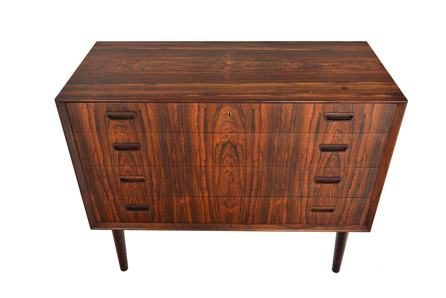 This jaw-dropping Danish modern midcentury gentleman’s chest features four extra wide drawers accented by hand carved rectangular drawer pulls. Designed by Borge Seindal, this stunning piece was manufactured on November 23rd, 1965, and is finished