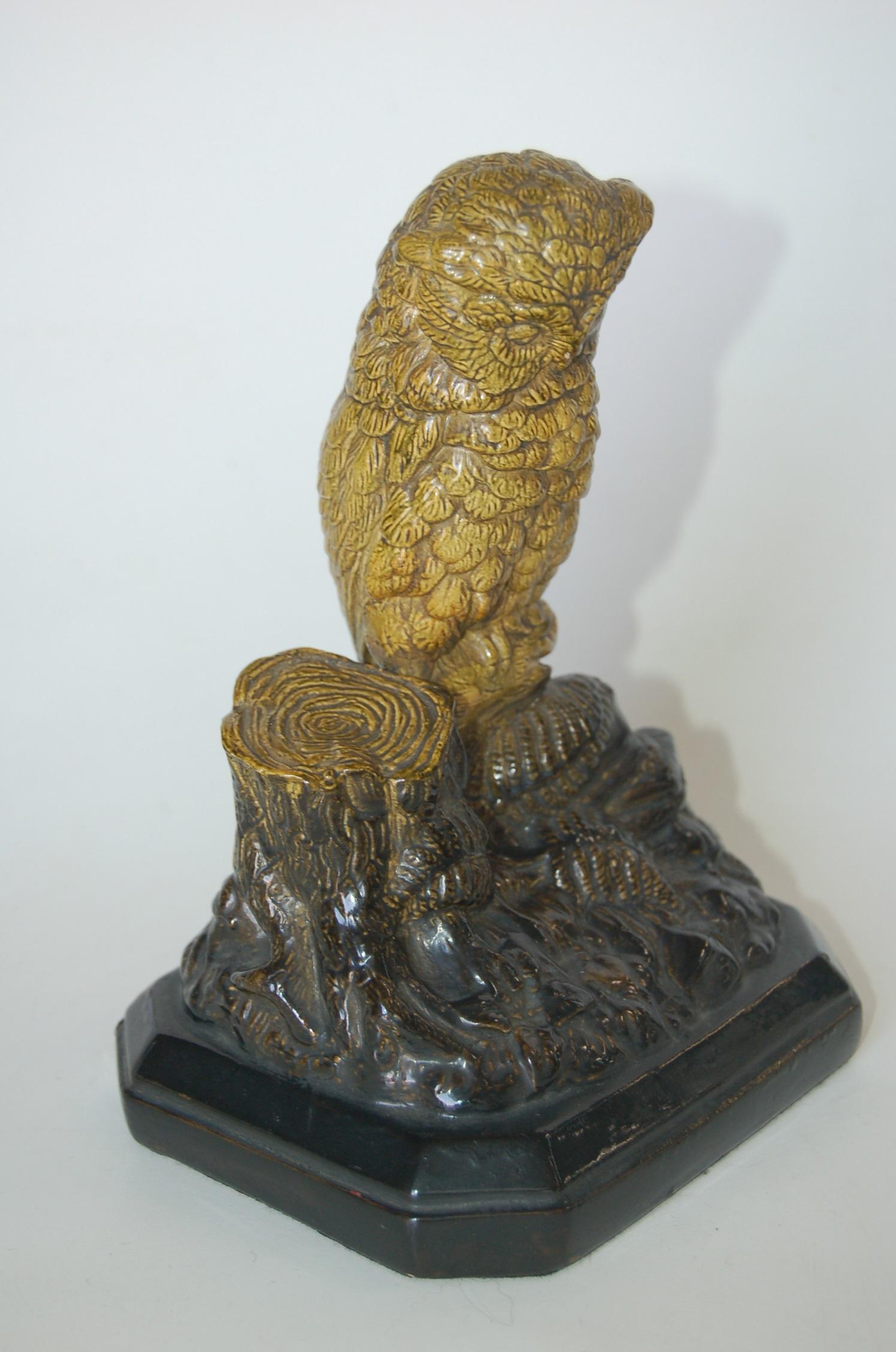 Borghese English Victorian period Majolica owl figurine. Lable and #123 underneath. 

Registry Date of November 9, 1871. 

Perched on a log on a rocky ground strewn with fern fronds. Glazed in green and black/brown. The eight-sided base is painted