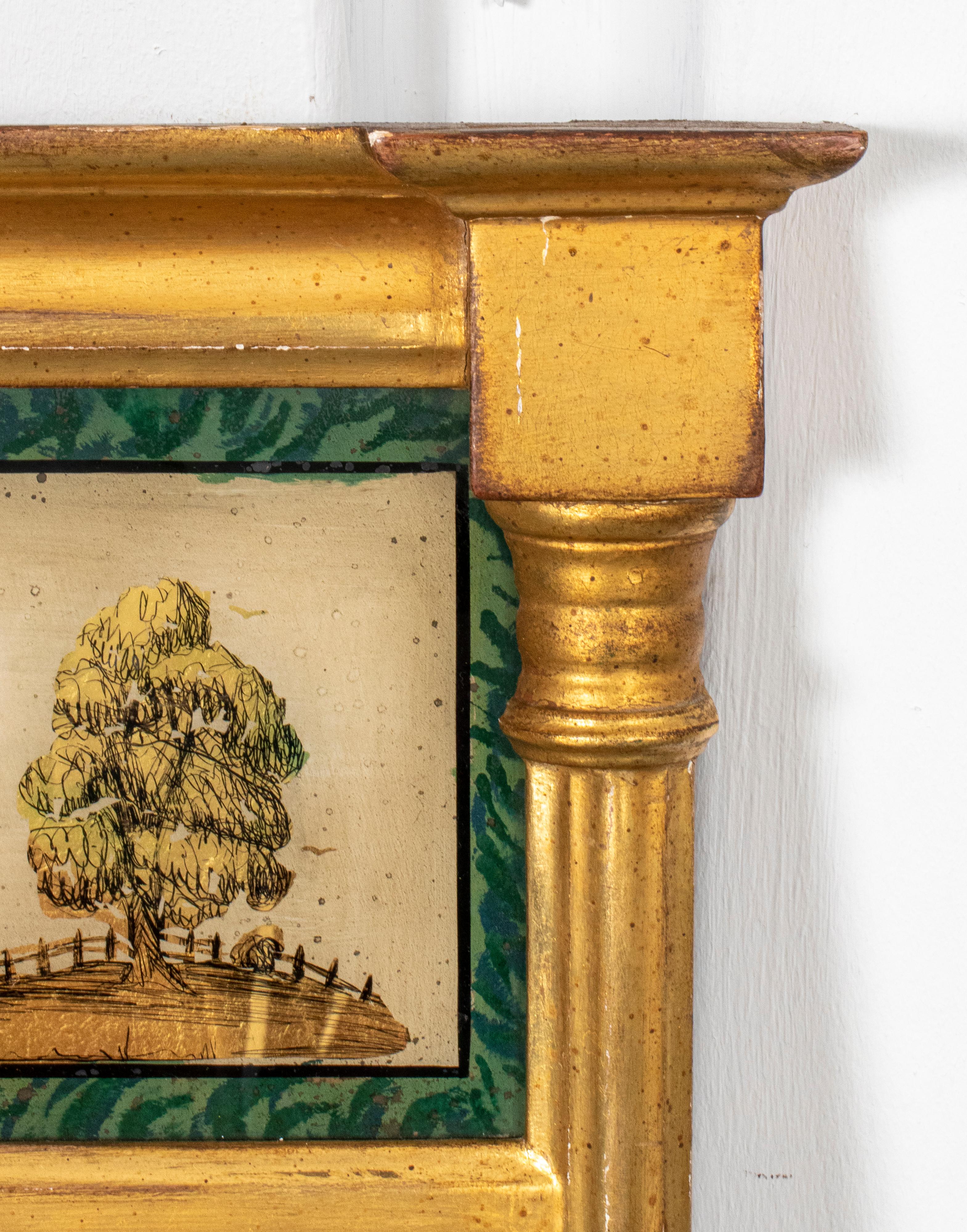 Borghese Neoclassical revival trumeau mirror with giltwood frame and painted glass panel depicting rural townscape with windmill, makers label on back. 32.5