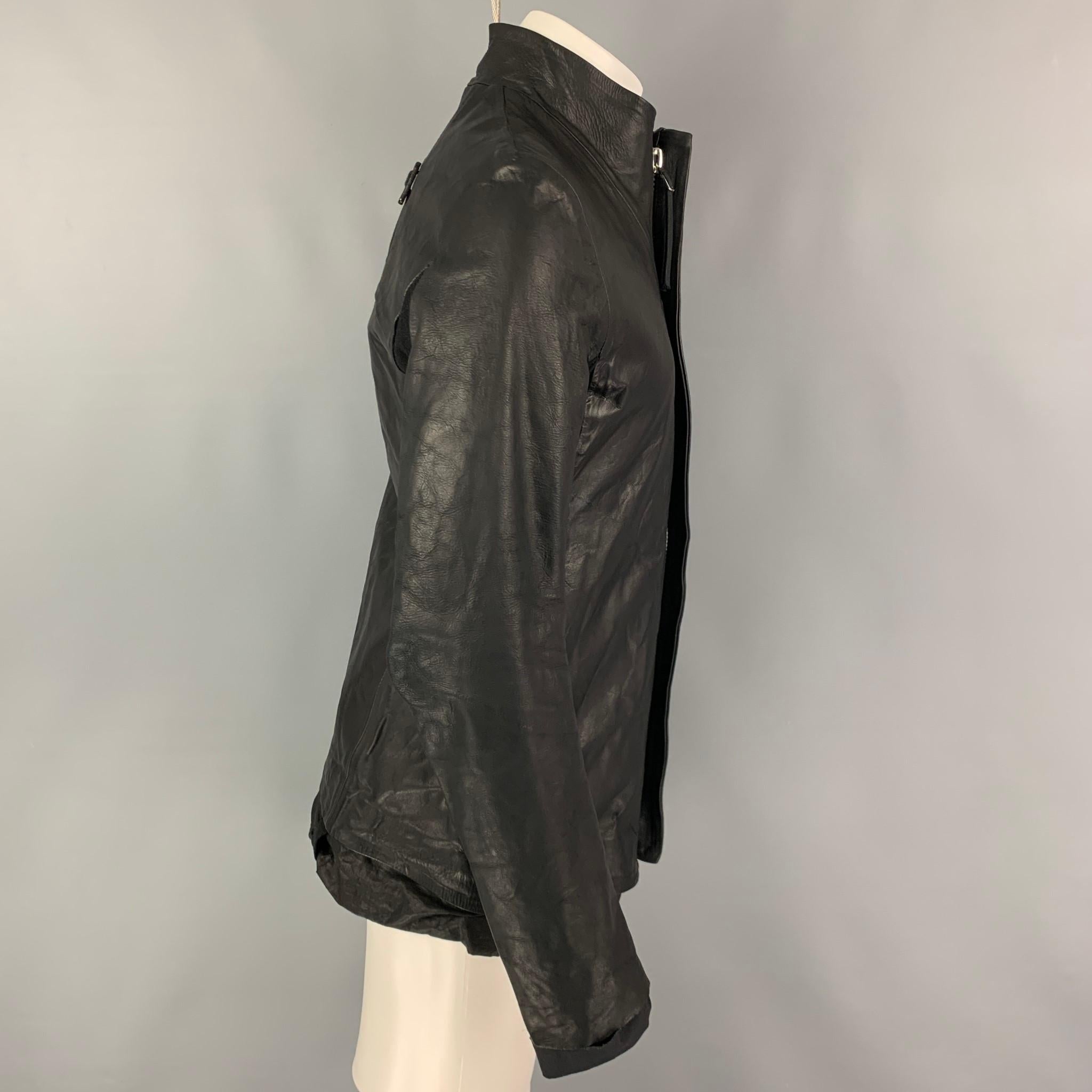 BORIS BIDJAN SABERI jacket comes in a black oil washed leather yak featuring a stand up collar, ribbed panels, slit pockets, and a hidden placket closure.

Excellent Pre-Owned Condition.
Marked: M
Original Retail Price: