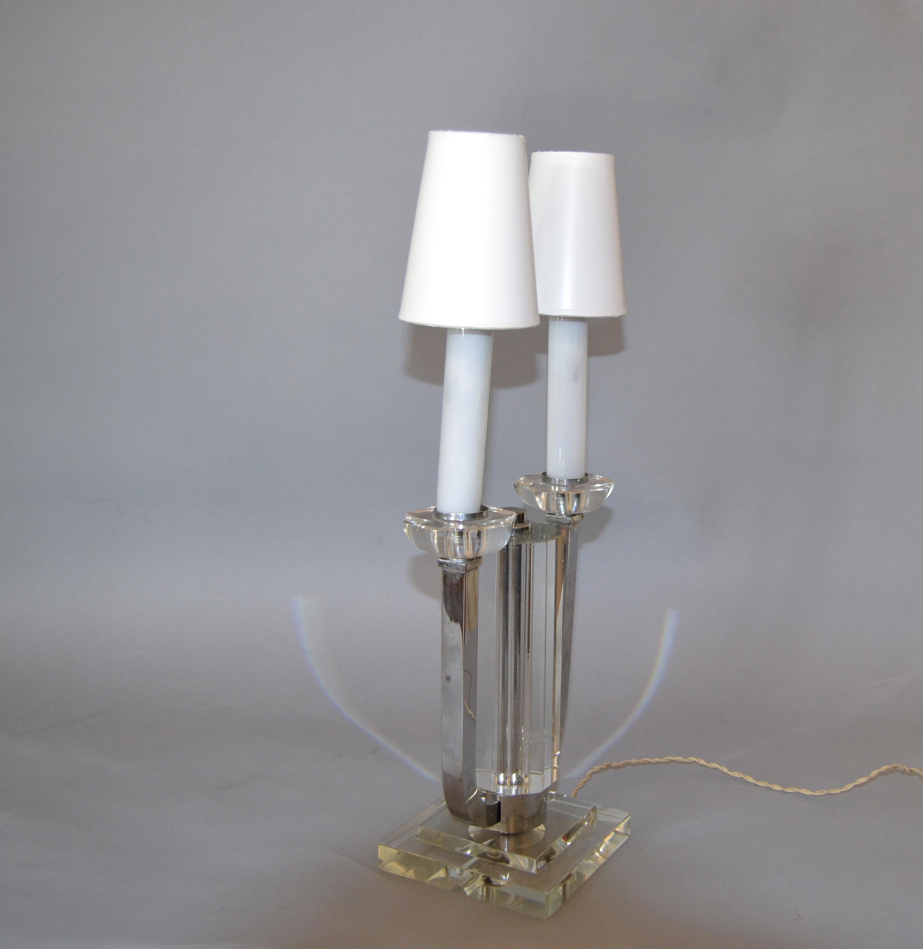 Boris Jean Lacroix French Art Deco nickel and crystal table lamp.
The crystal column in the center and 2 nickel arms holding the lights with shades.
In perfect working condition, with original French electrical components. We used the adapter for