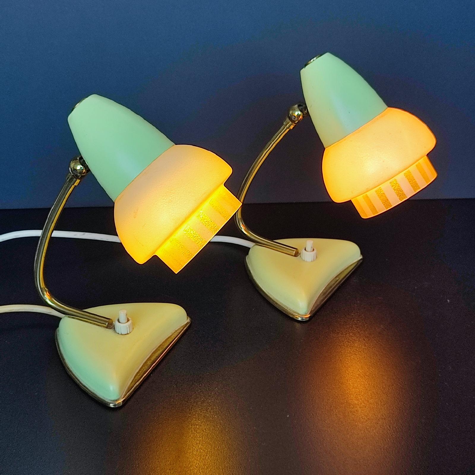 Pair of Lacroix Table Lamps from the 1940s – 1950s.
Metal or Brass-plated metal parts. Pistachio Yellow-green metal shades with frosted glass lampshade lower decorated with pistachio glass etched vertical stripes. Each lamp takes an E14 bulb. The