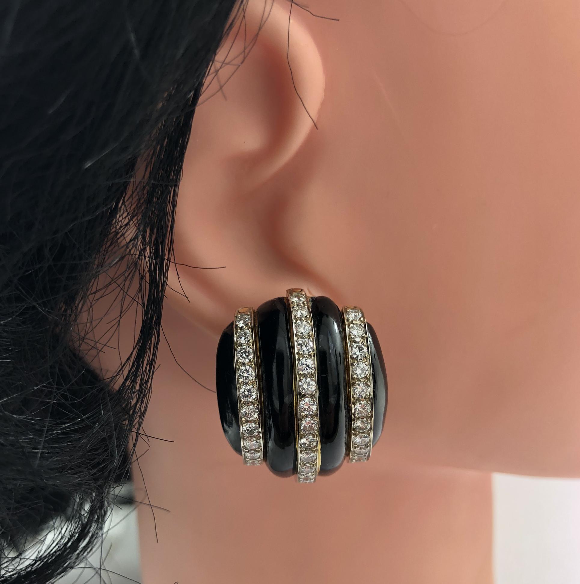 A pair of 18K yellow gold earrings, beautifully enameled in black, and each earring features 3 rows of diamonds. Designed by Boris LeBeau, these elegant earrings measure 1 3/8 inches long, and 1 inch wide. There are a total of 80 round brilliant cut