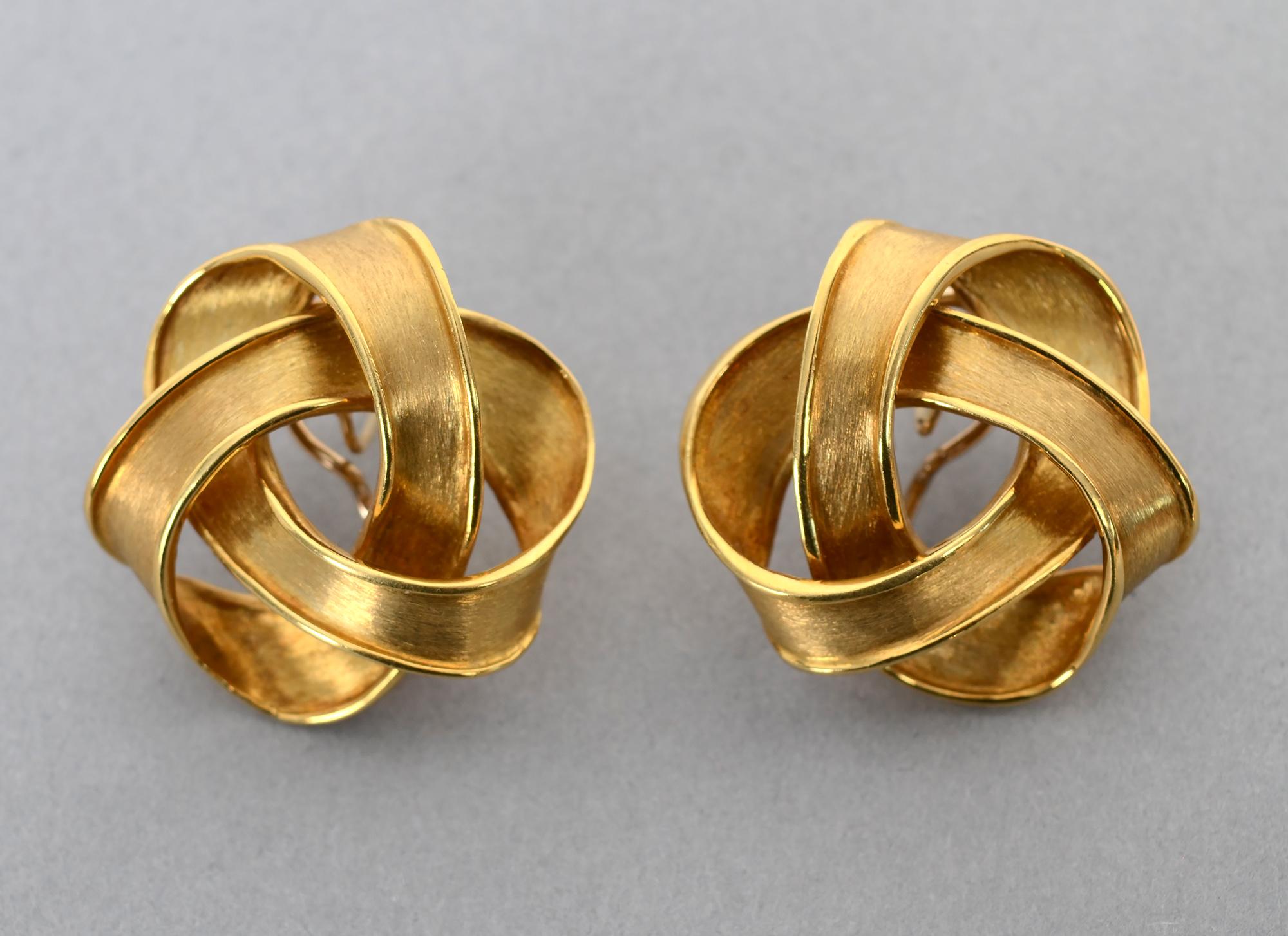 Large, sporty 18 karat gold earrings by the late New York designer, Boris LeBeau. The swirled design looks like intertwined ribbons.
The earrings  measure 1 7/16