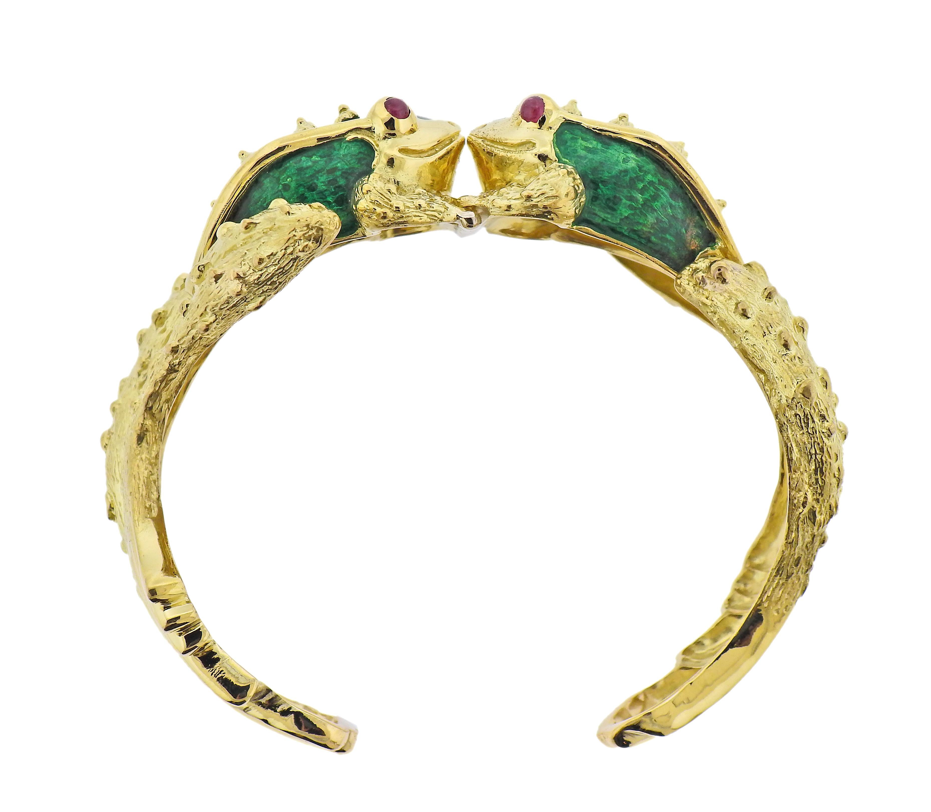 18k yellow gold cuff bracelet by Boris LeBeau, featuring enamel decorated frogs, with ruby cabochon eyes. Bracelet will fit approx. 7.5